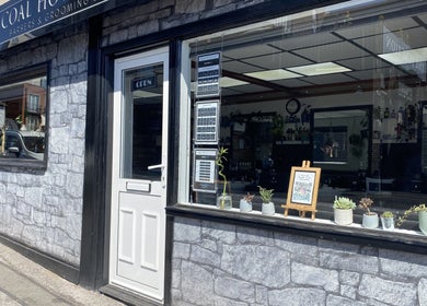 Exterior of Coal House Cuts in Upminster, England, showcasing its inviting storefront and stylish decor.