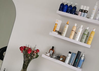 Product shelves at The Covered Pearl in Cape Town, Western Cape, ZA featuring hair care and wellness items.