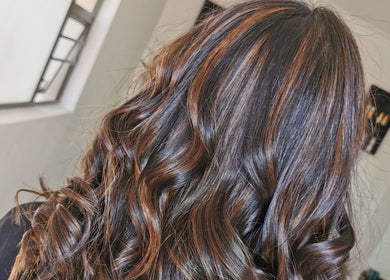 Glossy, curled hair styled at The Covered Pearl in Cape Town, Western Cape, ZA. Perfect for glam makeovers.