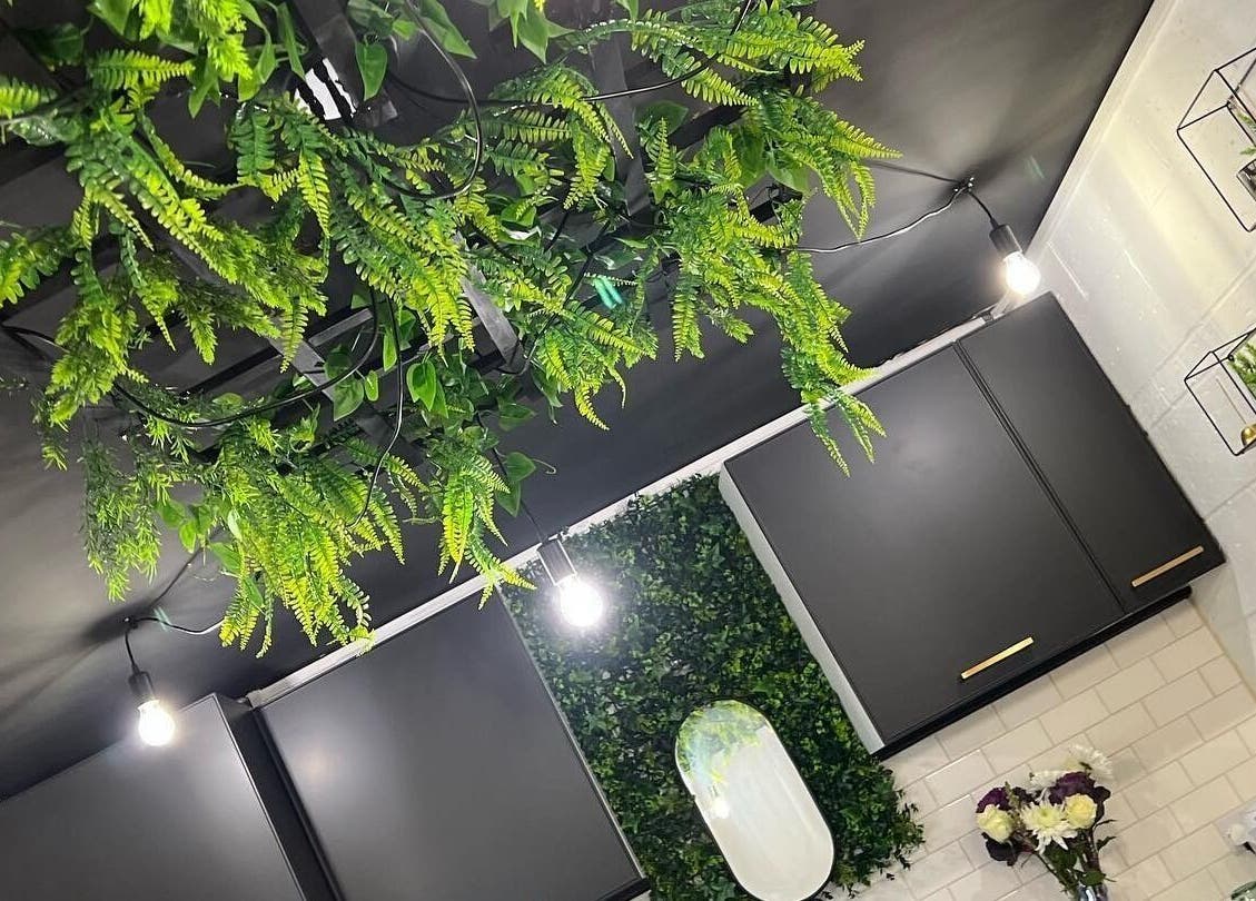 Fay Kathleen Beauty Aesthetics & Academy in Wigston, England, features a lush green ceiling decor.