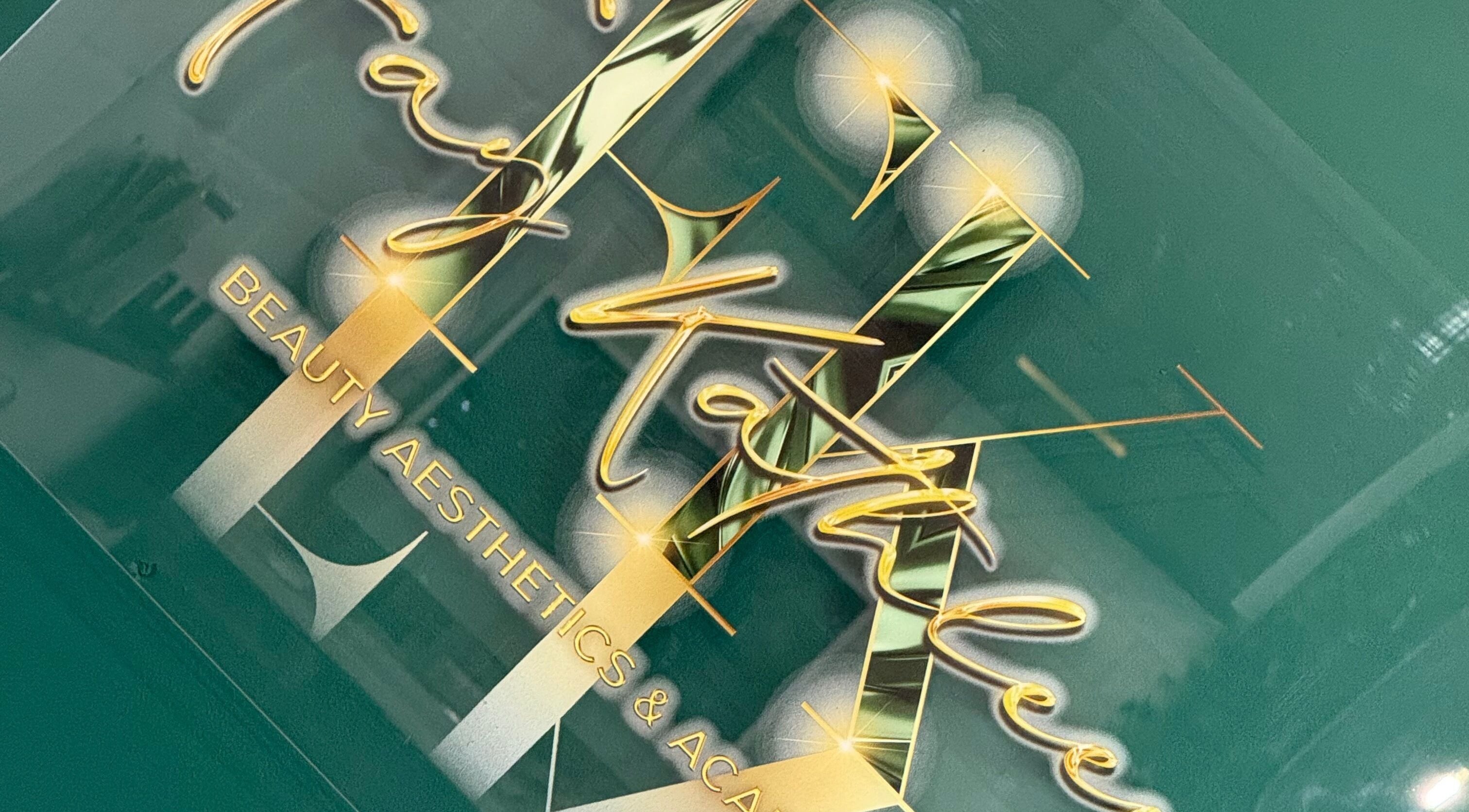 Logo of Fay Kathleen Beauty Aesthetics & Academy in Wigston, England, GB with gold lettering on a green background.