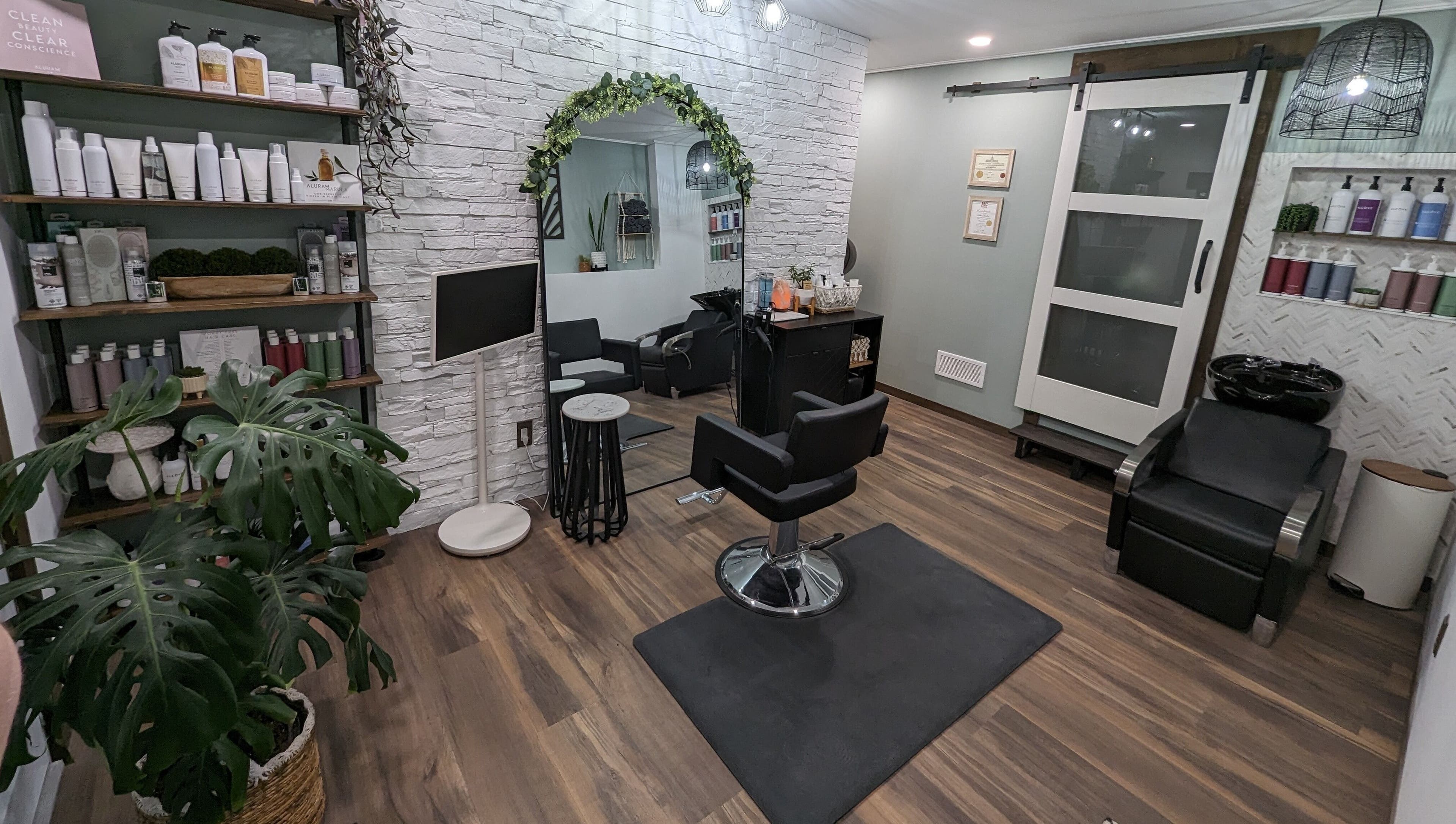 Trendy salon at So.Kal.Hair in West Kelowna, British Columbia, CA with modern decor and styling chair.