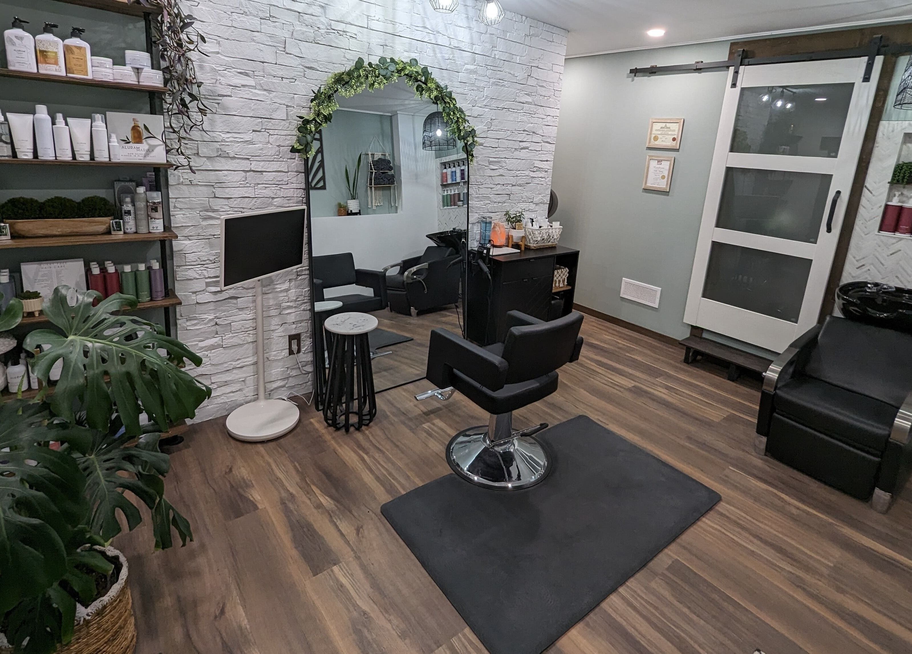 Trendy salon at So.Kal.Hair in West Kelowna, British Columbia, CA with modern decor and styling chair.