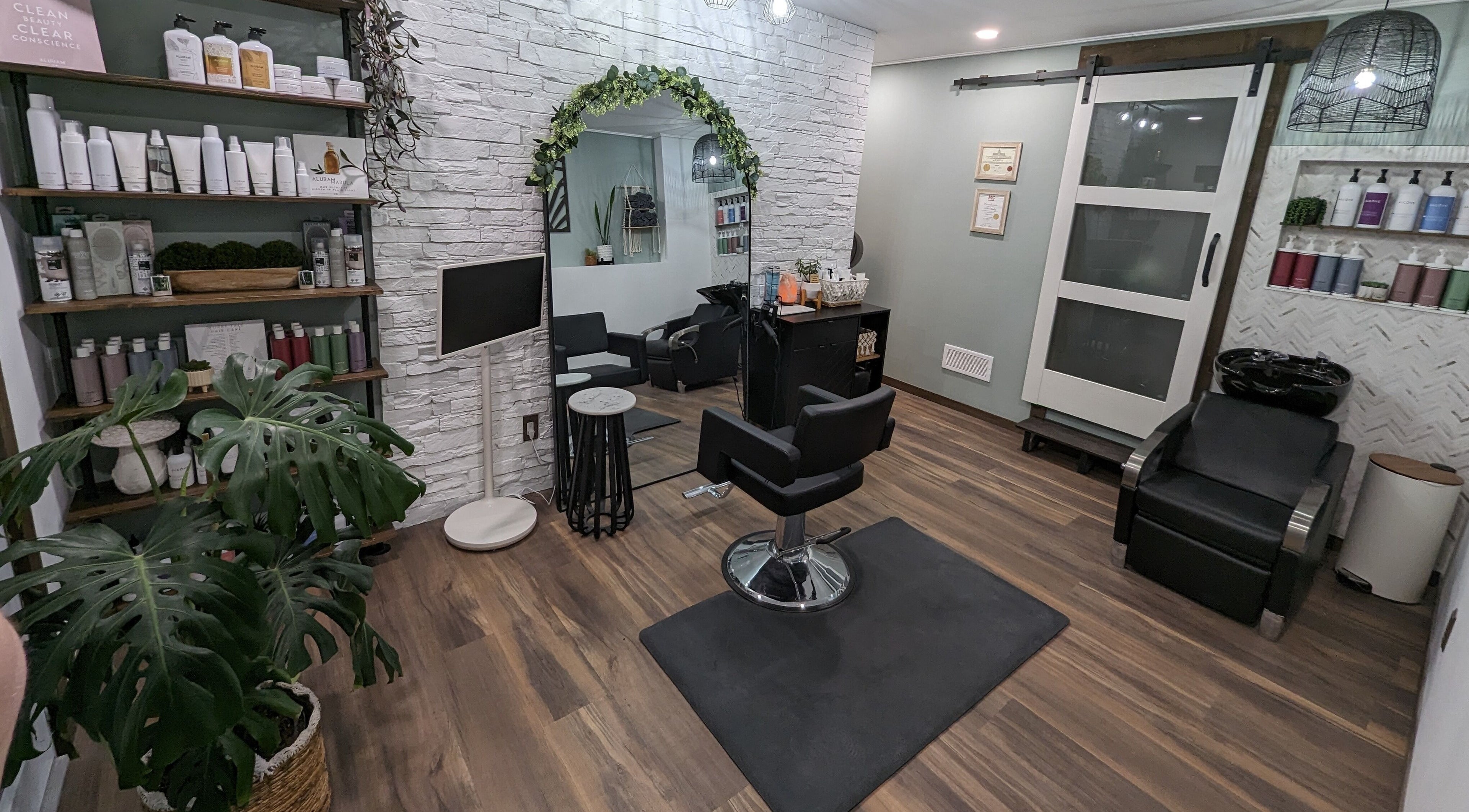 Trendy salon at So.Kal.Hair in West Kelowna, British Columbia, CA with modern decor and styling chair.