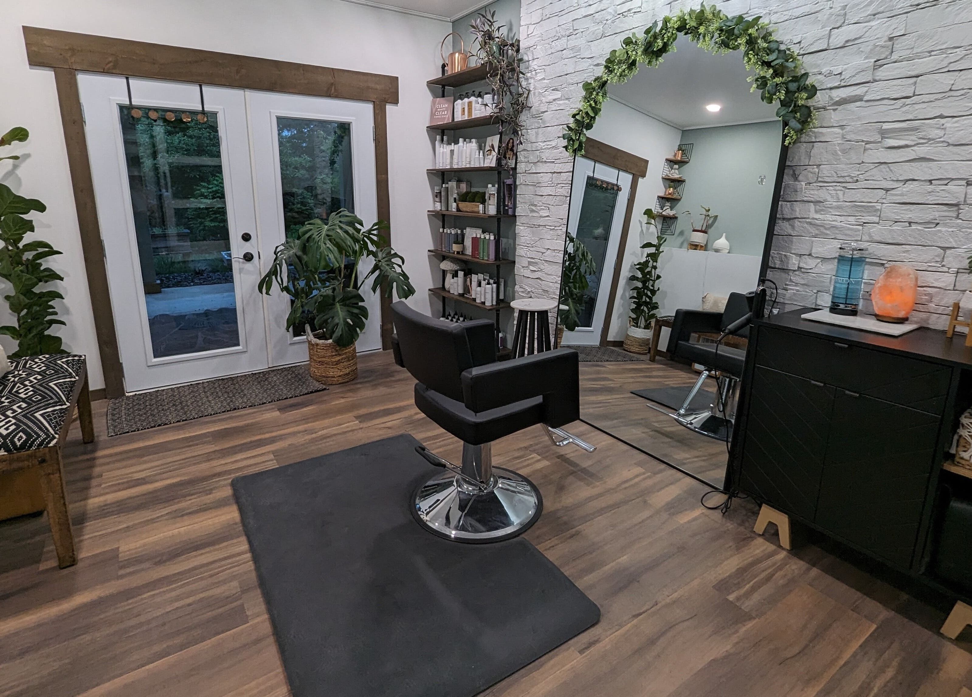 Modern salon interior at So.Kal.Hair in West Kelowna, British Columbia, CA featuring stylish decor and mirrors.