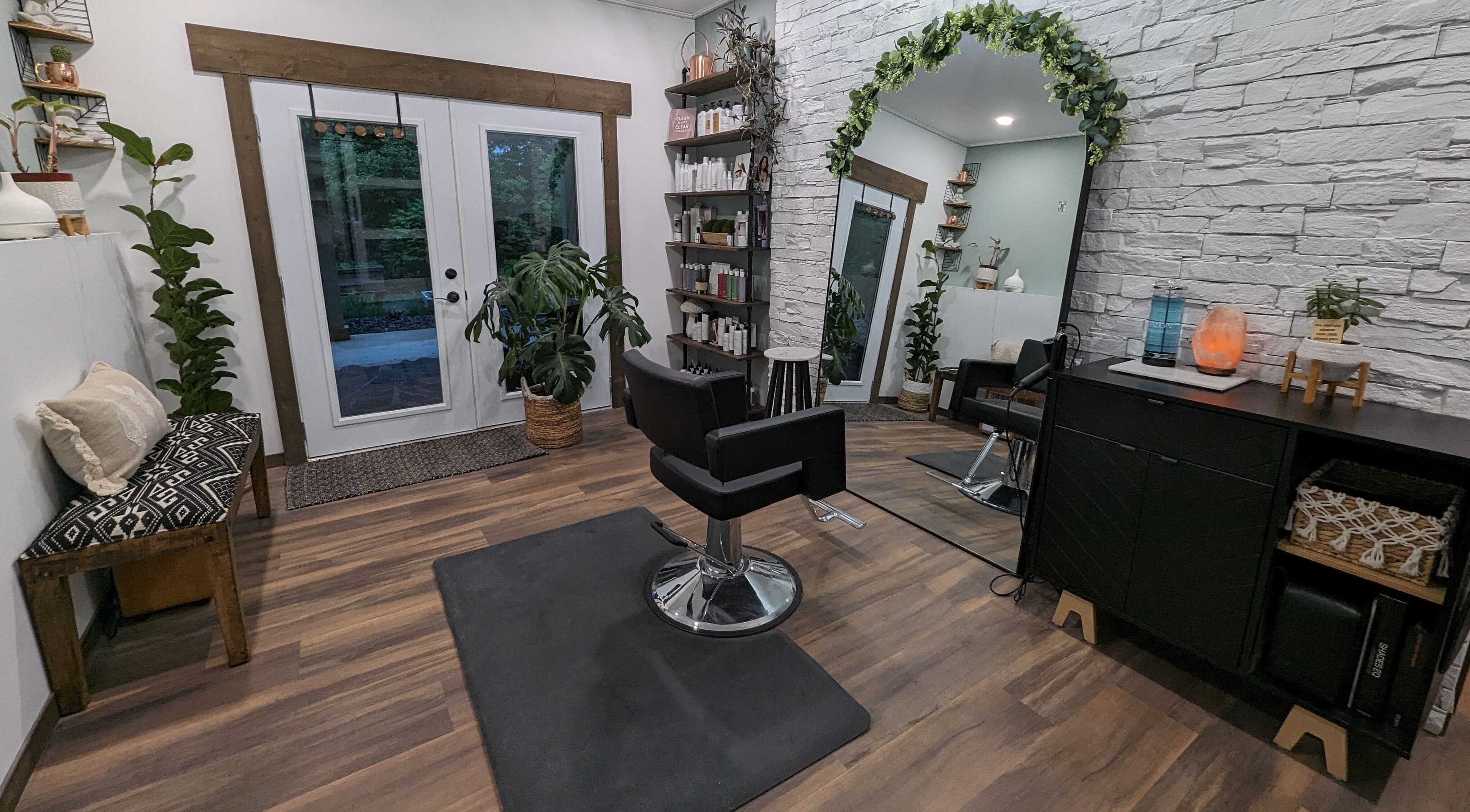 Modern salon interior at So.Kal.Hair in West Kelowna, British Columbia, CA featuring stylish decor and mirrors.