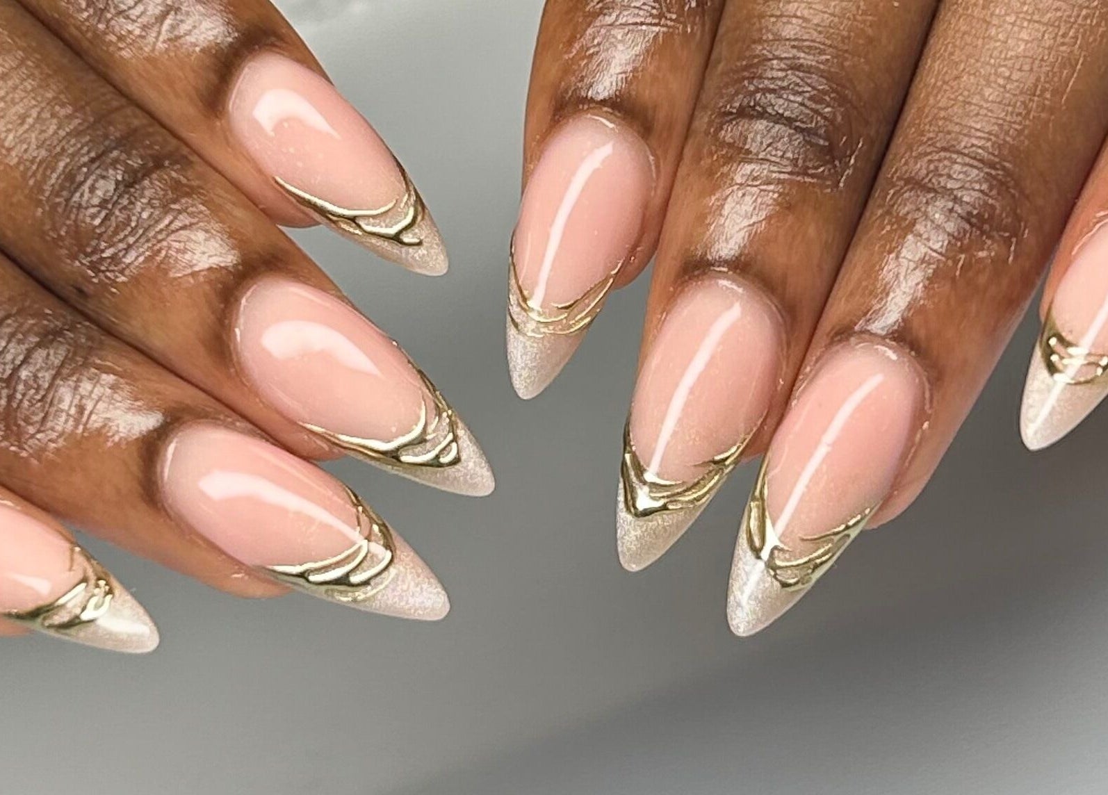 Elegant nude and gold nail art at Mani by Jay in London, England, GB showcasing exquisite craftsmanship.