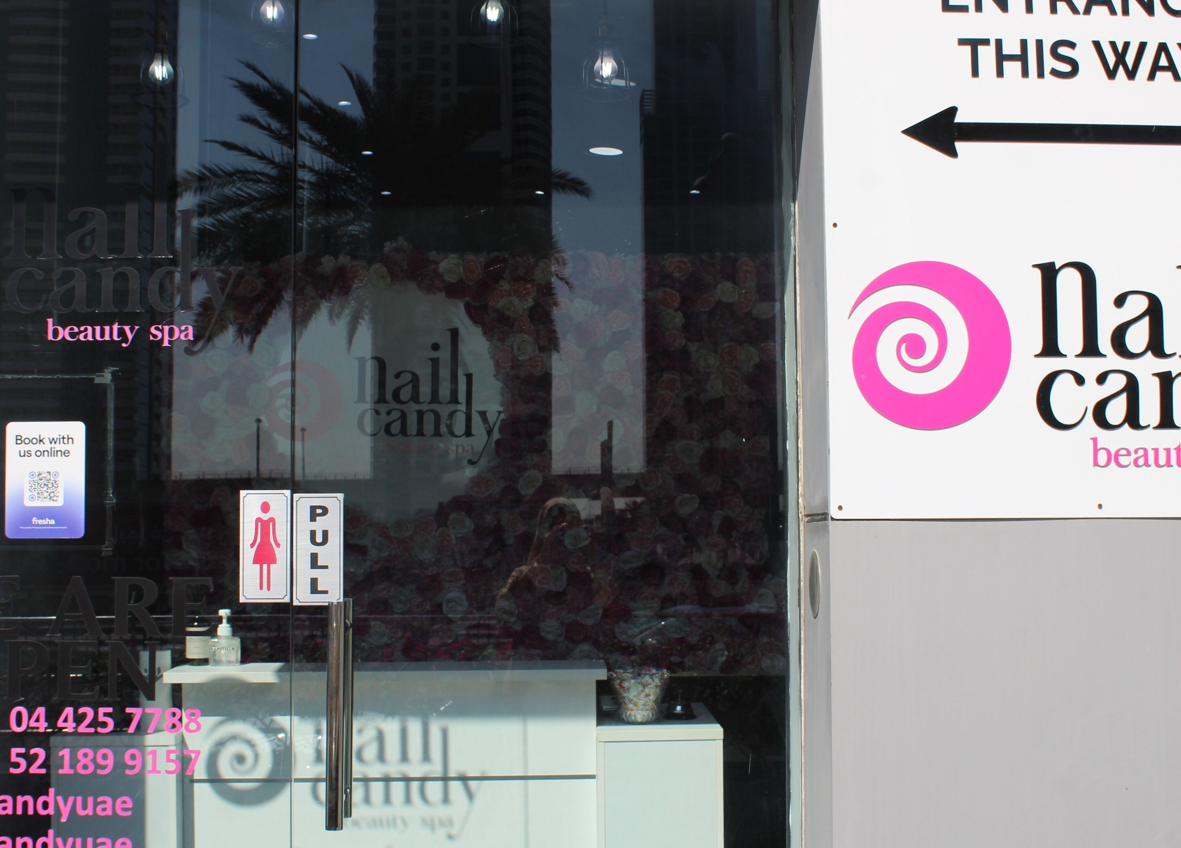 Front entrance of Nail Candy beauty spa in Dubai, Dubai, AE, featuring modern signage and contact details.