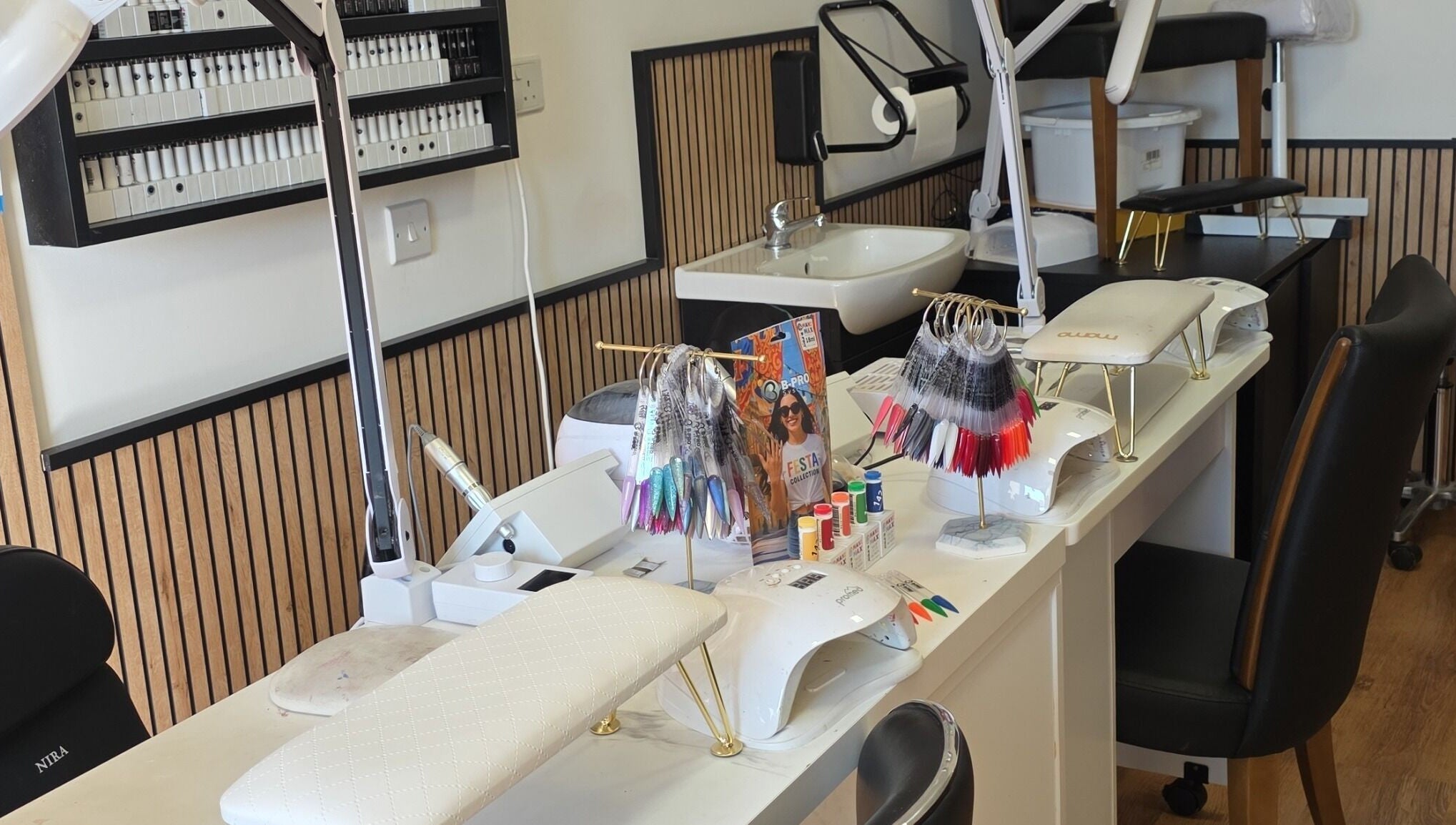 Manicure stations showcasing tools and nail colors at Pampered by Maya, L-imqabba, MT.