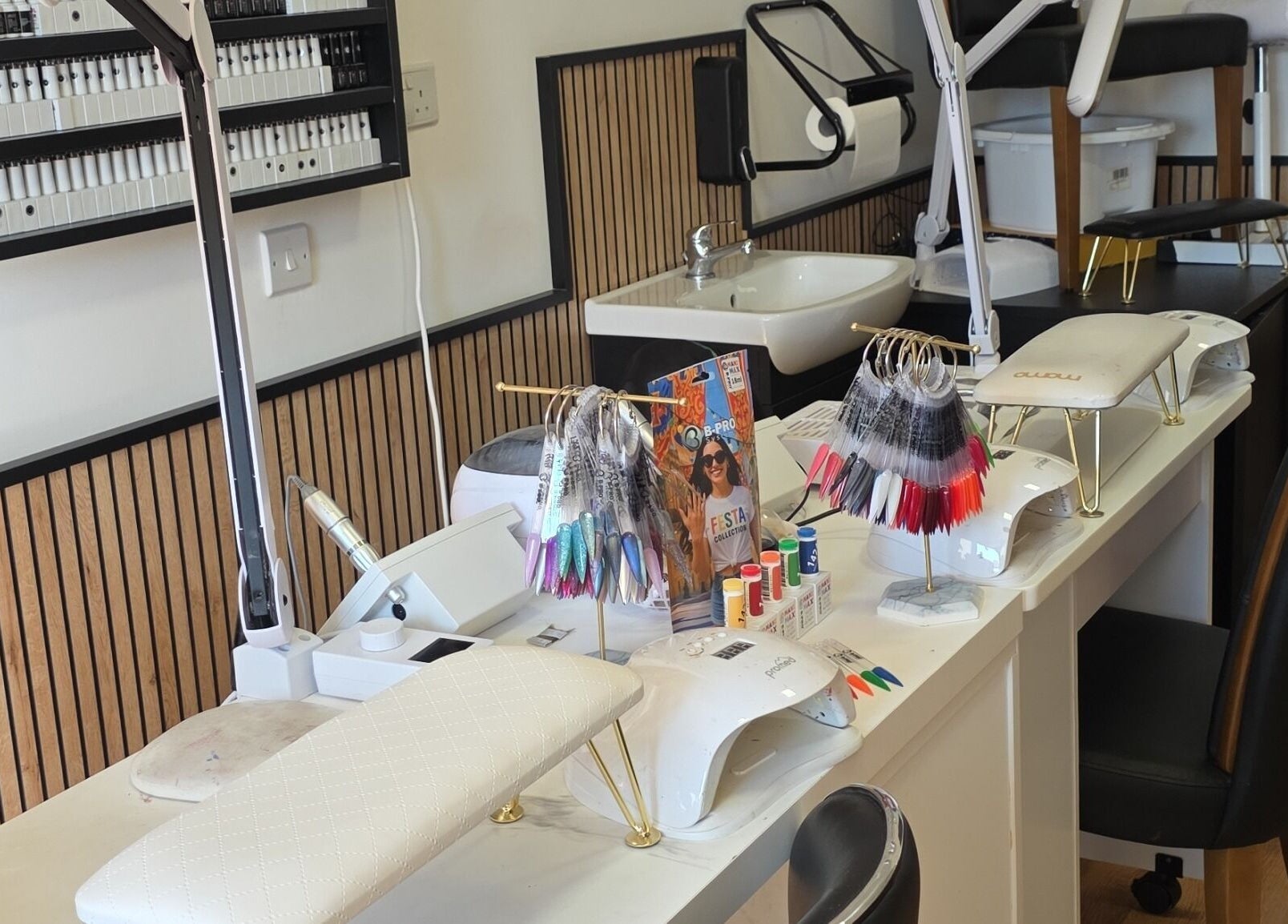 Manicure stations showcasing tools and nail colors at Pampered by Maya, L-imqabba, MT.