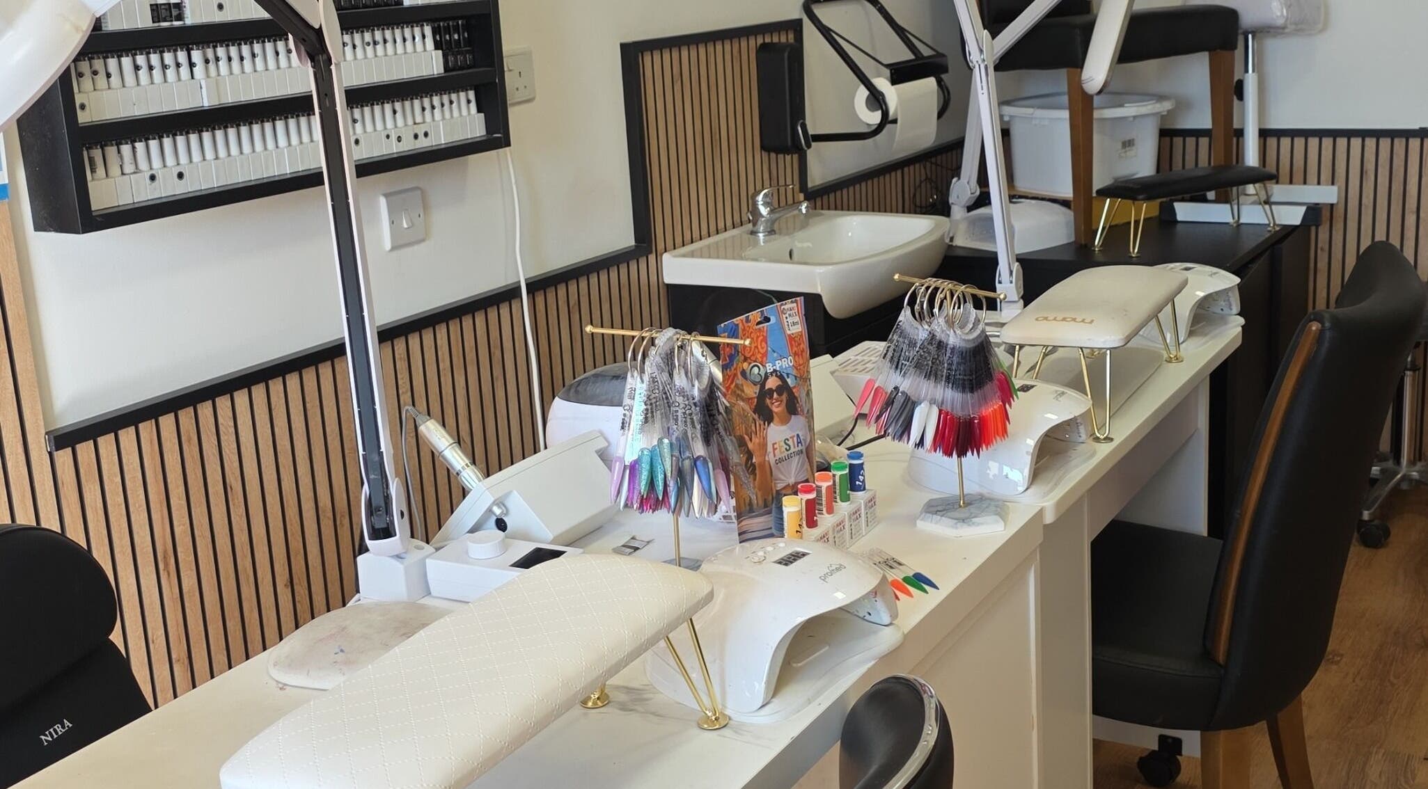 Manicure stations showcasing tools and nail colors at Pampered by Maya, L-imqabba, MT.