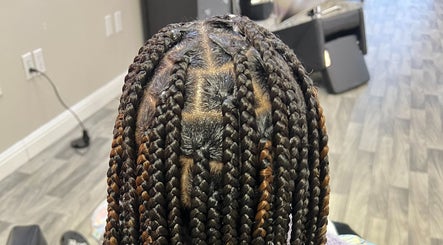 Intricate braided hairstyle at Naturally D’ Fine Beauty in Greensboro, North Carolina, US.