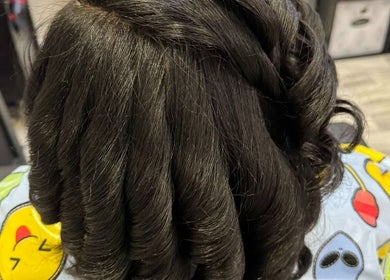 Elegant curls styled at Naturally D’ Fine Beauty in Greensboro, North Carolina, US. Detailed top view.