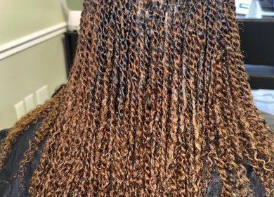 Stylish braids at Naturally D’ Fine Beauty salon in Greensboro, North Carolina, US.