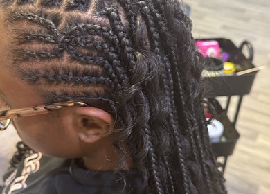 Detailed braiding at Naturally D’ Fine Beauty, Greensboro, North Carolina, US, showcasing skilled hairstyling.
