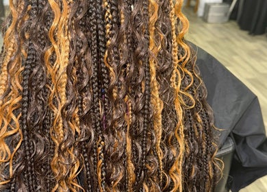 Styled braids at Naturally D’ Fine Beauty in Greensboro, North Carolina, US, showcasing vibrant texture.