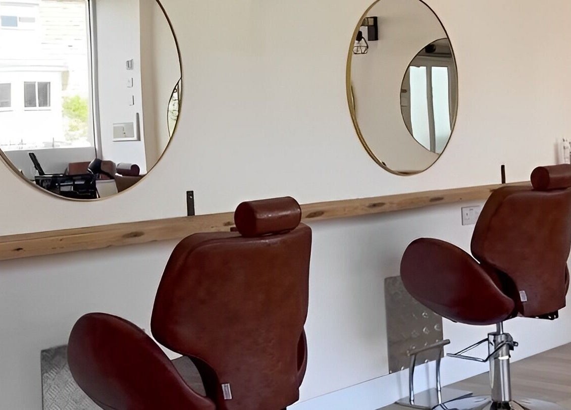 Modern salon chairs and mirrors at Omor Studio, Wetherby, England, GB offer a luxurious beauty experience.