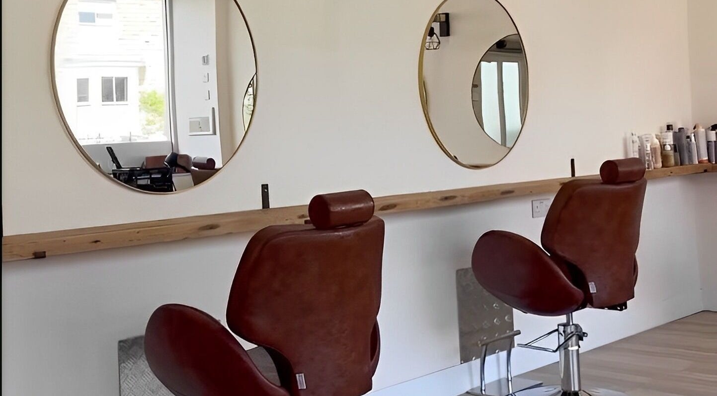 Modern salon chairs and mirrors at Omor Studio, Wetherby, England, GB offer a luxurious beauty experience.