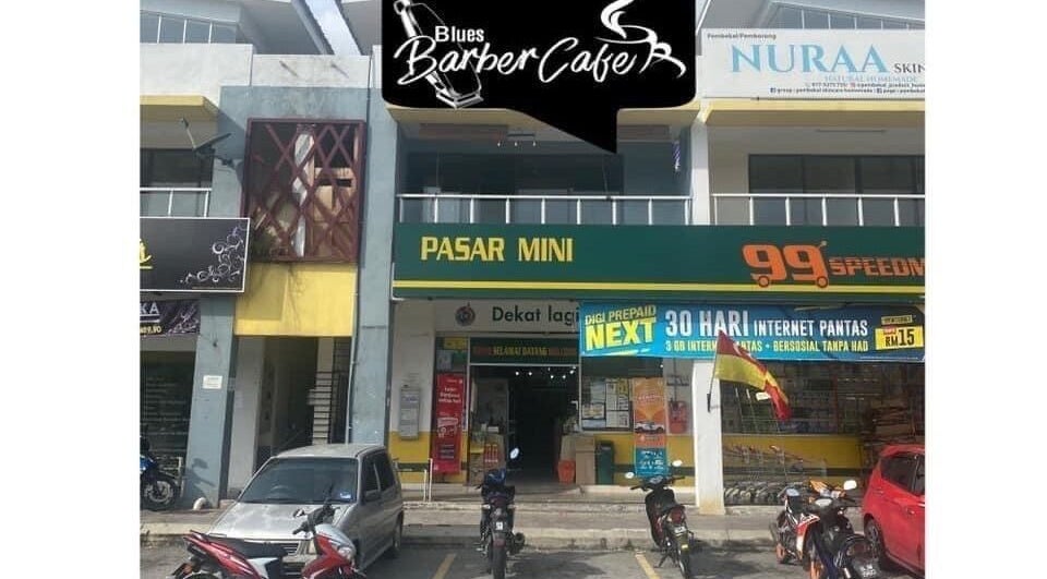 Front view of Blues Barbershop, located at Sungai Buloh, Selangor, MY, beside convenience stores.