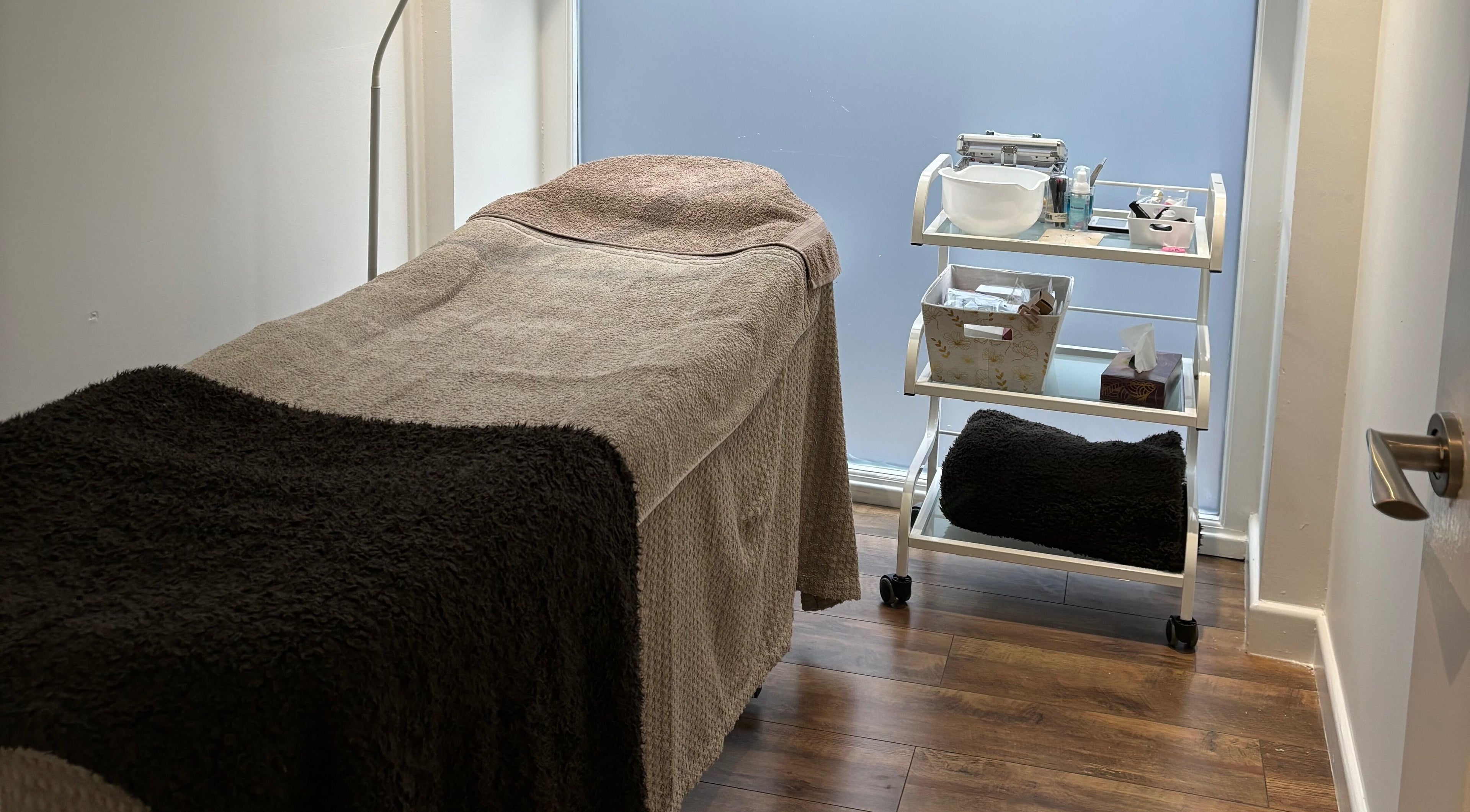 Cozy treatment room at Oasis Beauty Salon, Altrincham, England, GB set for a relaxing spa experience.