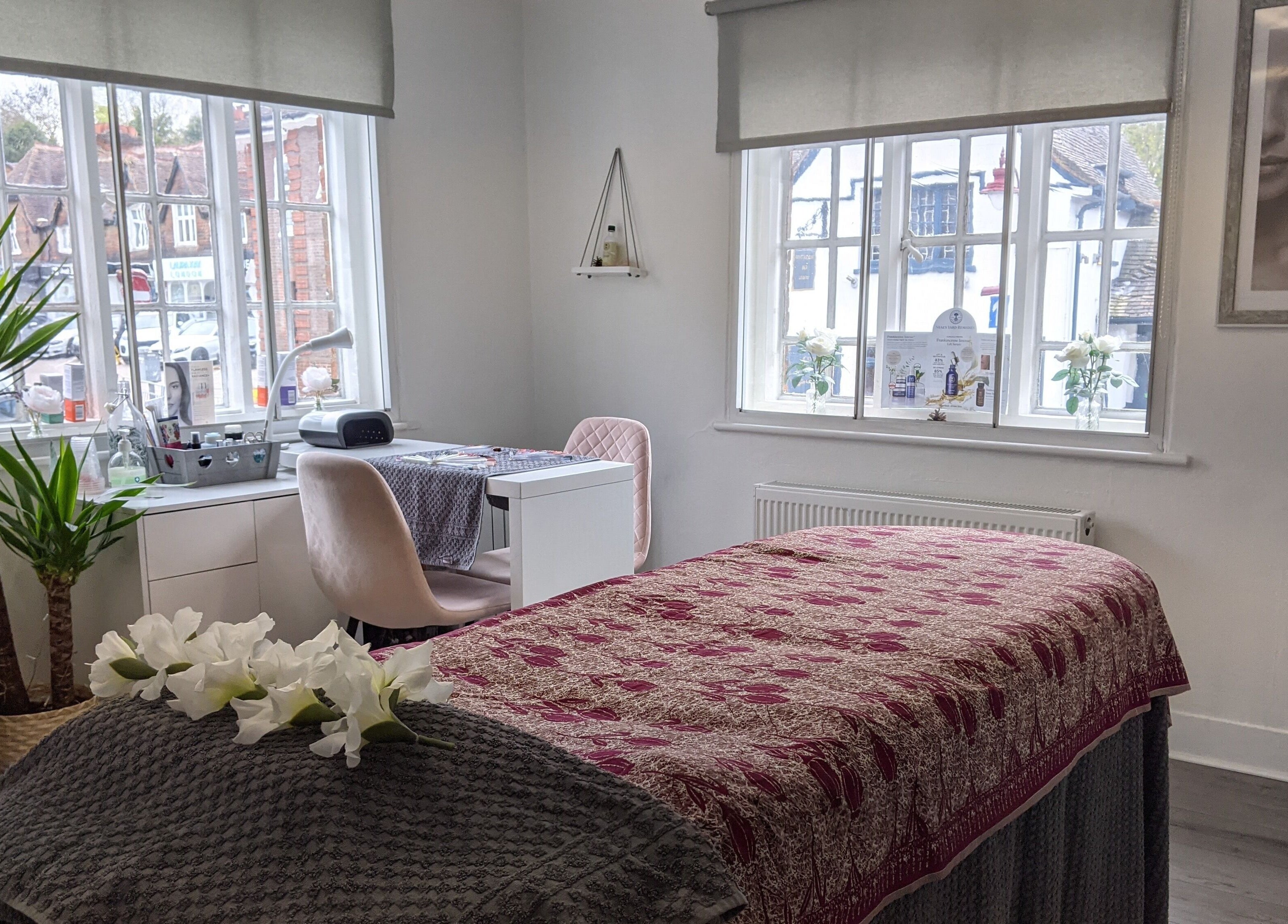 Serene treatment room at Beauty in the Woods, Radlett, England, GB with cozy decor and warm natural light.