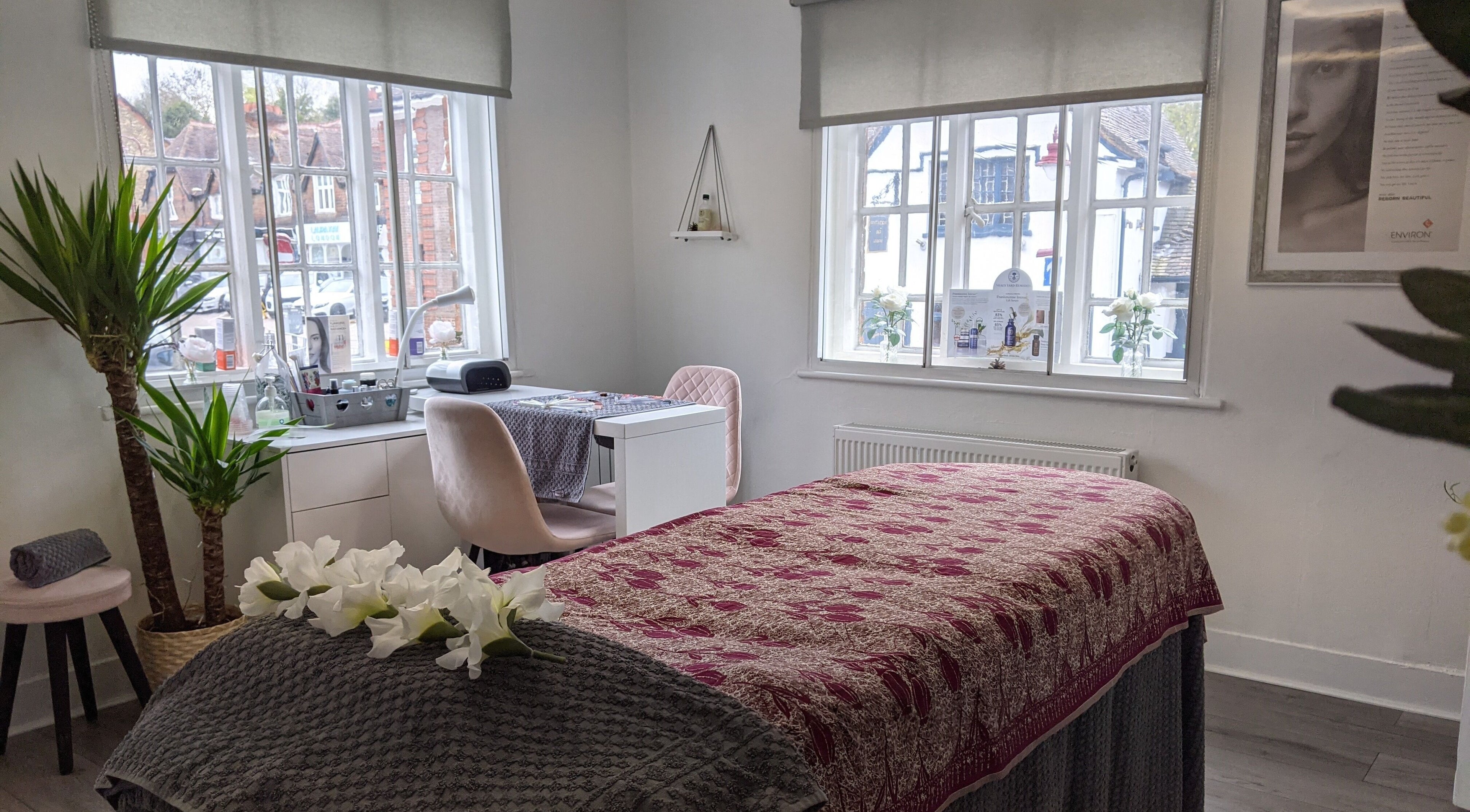 Serene treatment room at Beauty in the Woods, Radlett, England, GB with cozy decor and warm natural light.