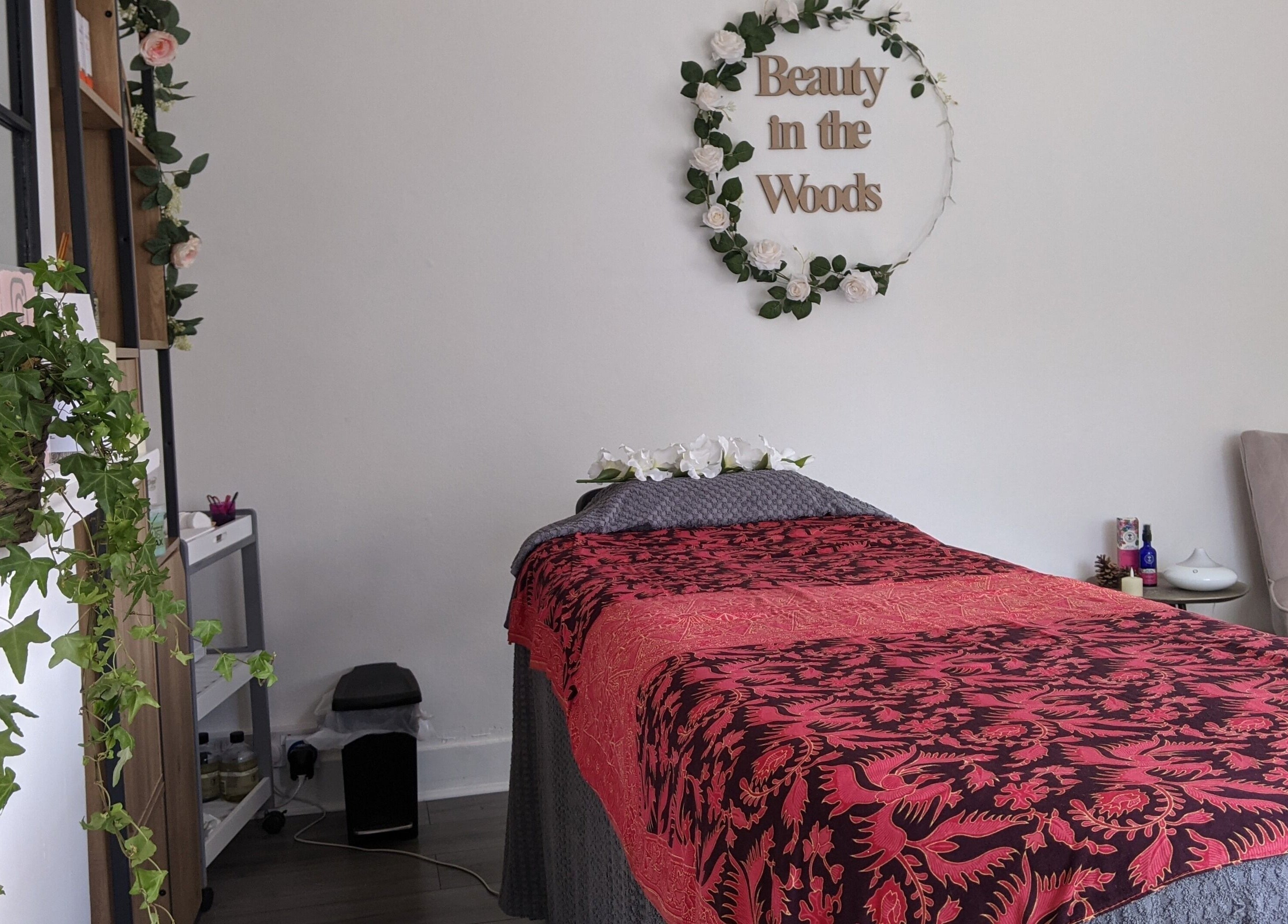 Tranquil wellness suite at Beauty in the Woods, Radlett, England, GB with a floral-accented treatment area.