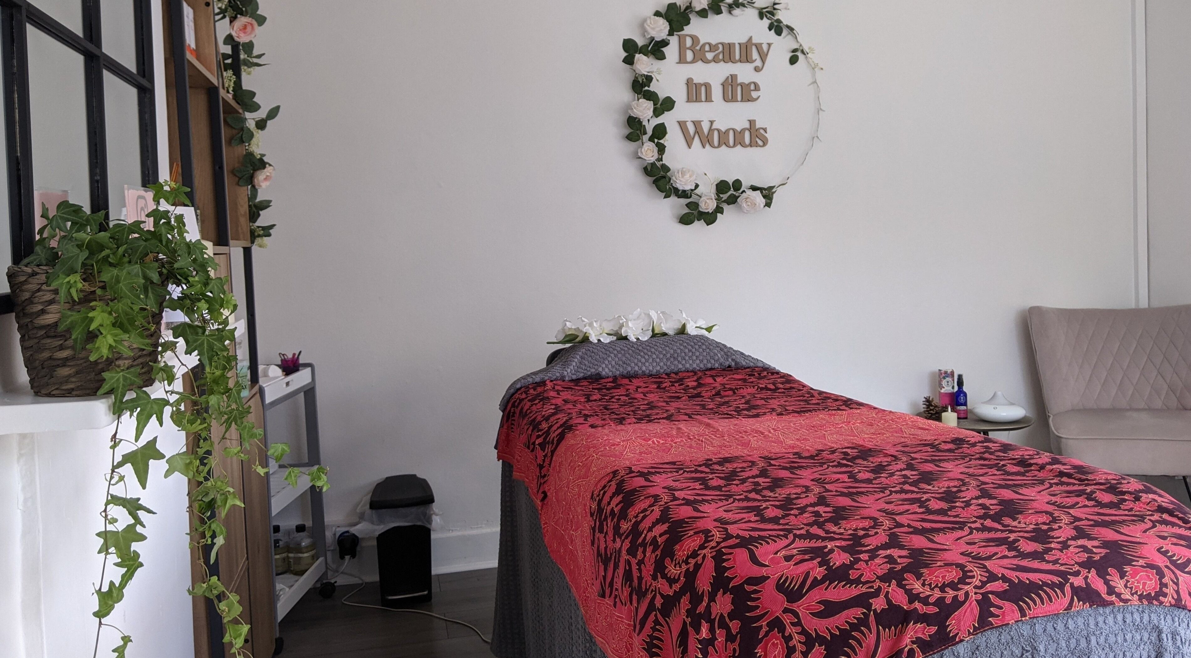 Tranquil wellness suite at Beauty in the Woods, Radlett, England, GB with a floral-accented treatment area.