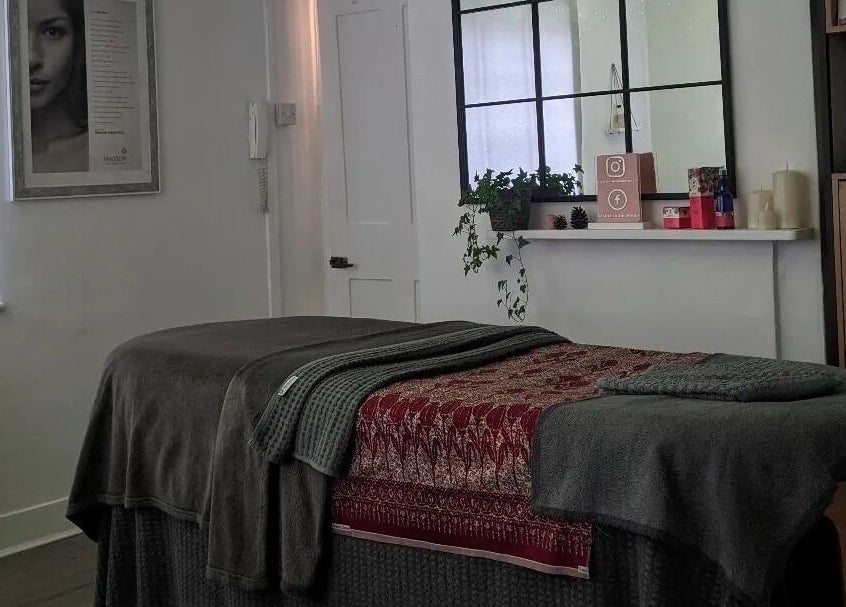 Tranquil treatment room at Beauty in the Woods, Radlett, England, GB, with massage table and decor.