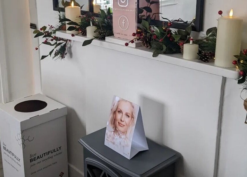 Inviting decor at Beauty in the Woods, Radlett, England. Features candles and green garlands.