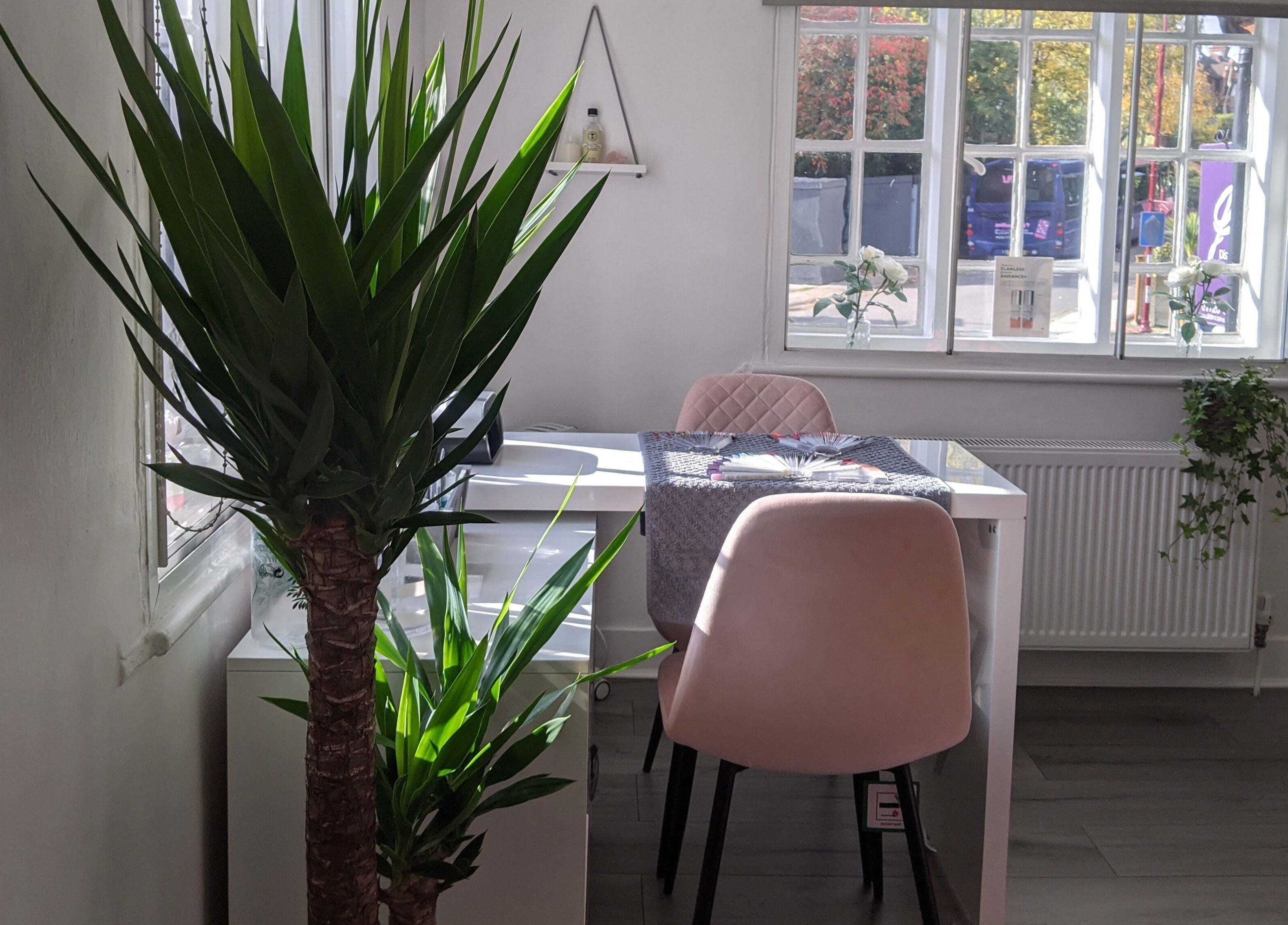Cozy beauty space at Beauty in the Woods, Radlett, England, GB with natural light and lush greenery.