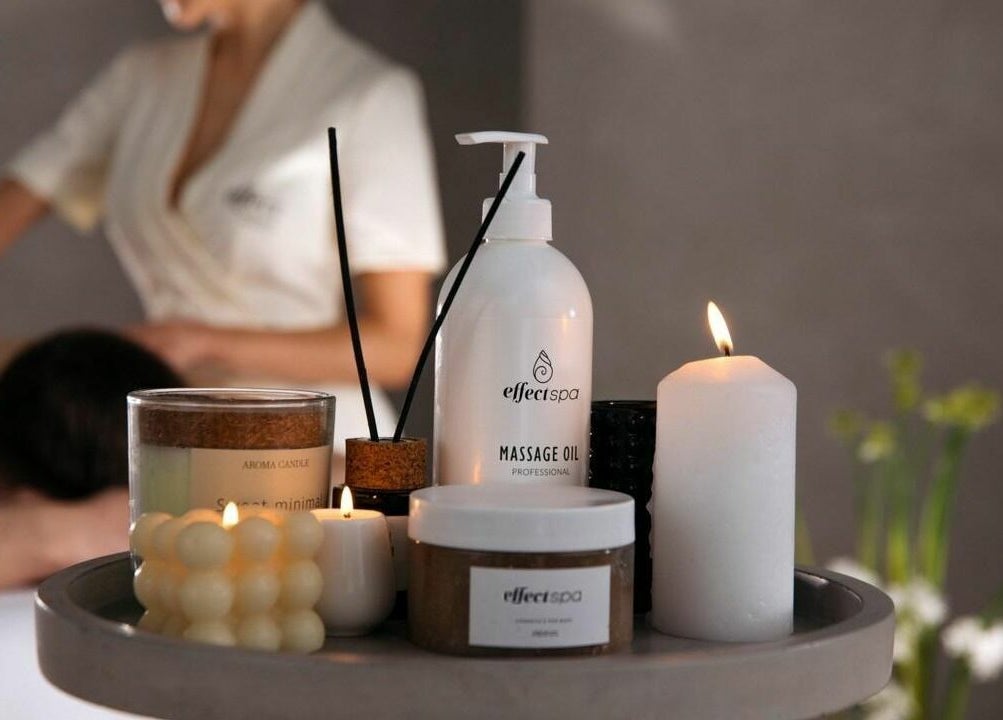 Relaxing massage table setup with candles and oils at Effect Spa, Dubai, Dubai, AE, promoting tranquility.