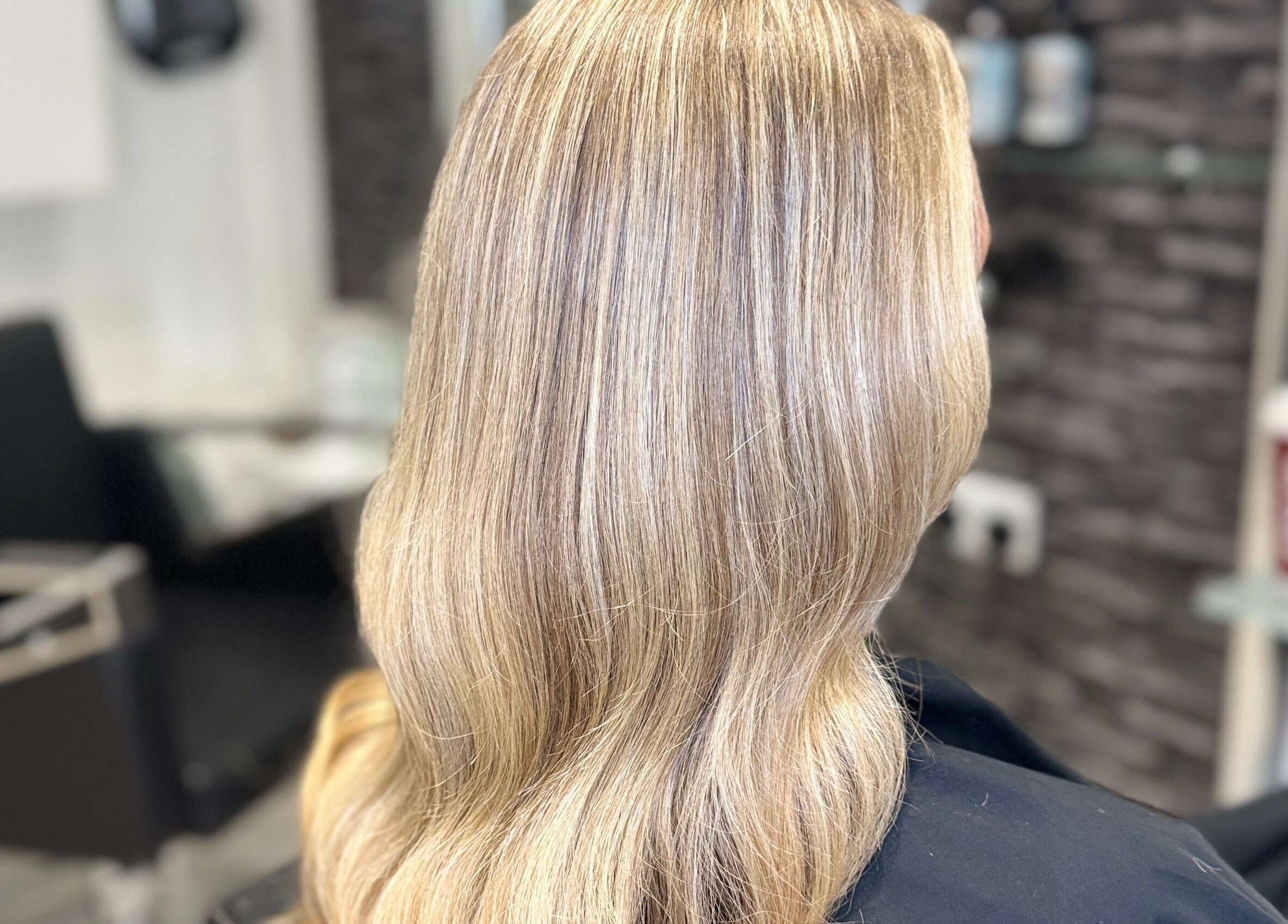 Blonde hair styled in sleek waves at Hair and Aesthetics by Sophie, Marlow, England, GB.