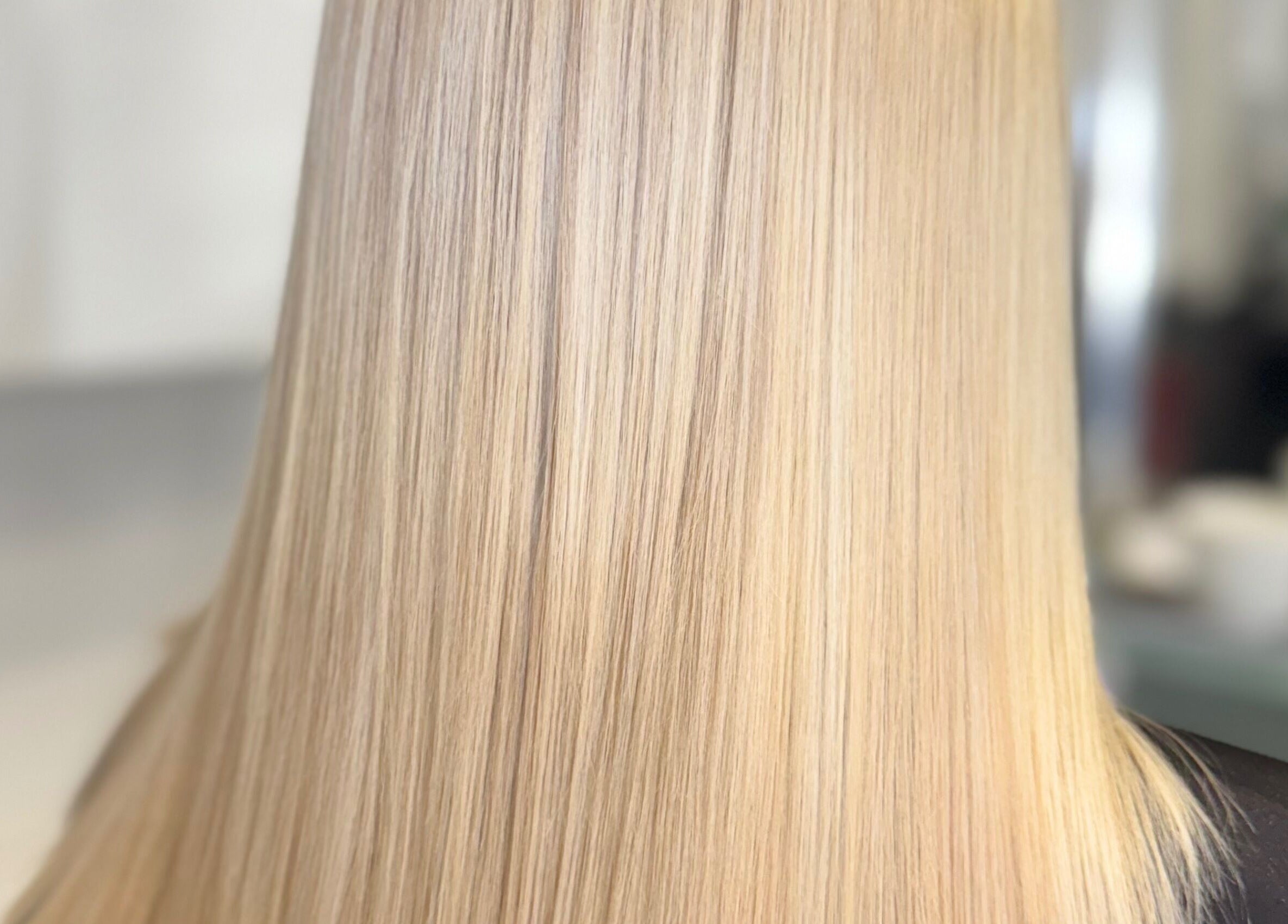 Close-up of silky smooth blonde hair at Hair and Aesthetics by Sophie, Marlow, England, GB.