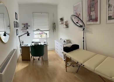 Modern treatment room at iloNails.tech, Worcester, England, GB. Elegant decor with nail station and massage bed.