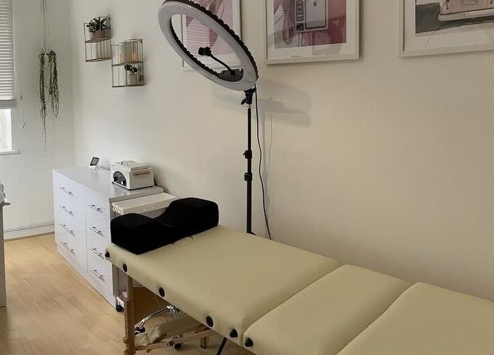 Relaxing treatment room at iloNails.tech, Worcester, England, GB with a massage bed and beauty tools.