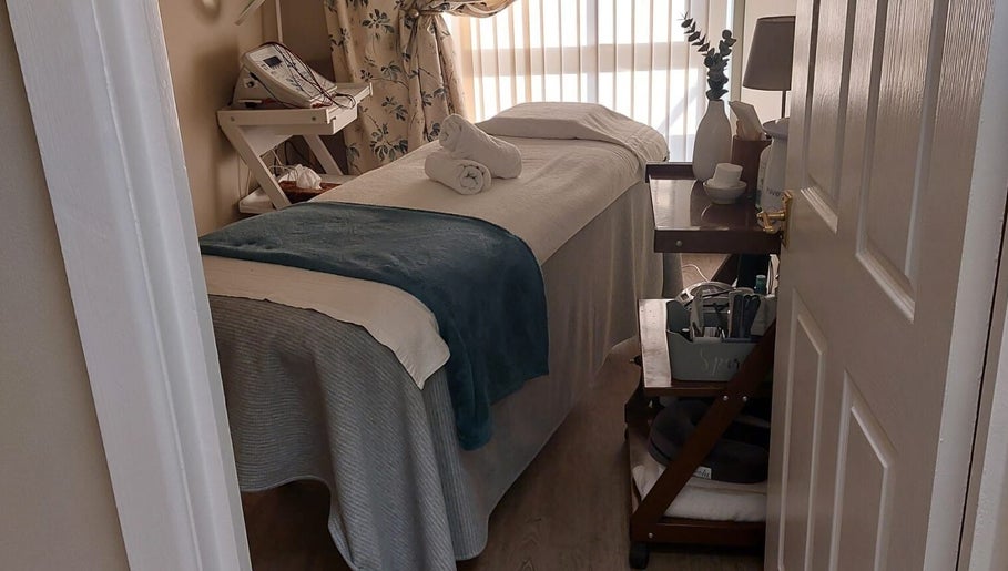 Tranquil treatment room at Select Beauty Salon, York, England, GB, showcasing a cozy massage table and calming decor.