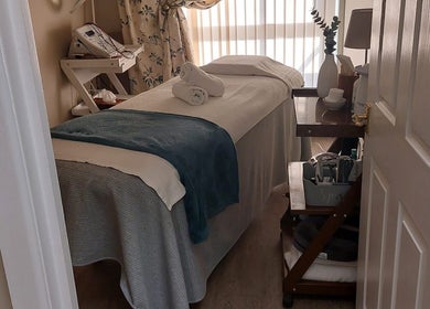 Tranquil treatment room at Select Beauty Salon, York, England, GB, showcasing a cozy massage table and calming decor.