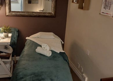 Cozy treatment room at Select Beauty Salon, York, England, GB, featuring a prepared massage bed.