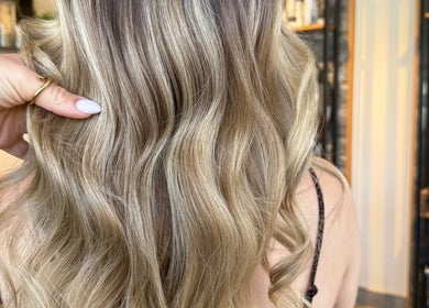 Stylish wavy blonde hairstyle at Vanity, Stoke-on-Trent, England, GB. Perfect salon finish.