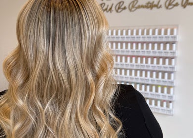 Blonde wavy hairstyle at Vanity salon in Stoke-on-Trent, England, GB, showcasing luxurious hair treatments.