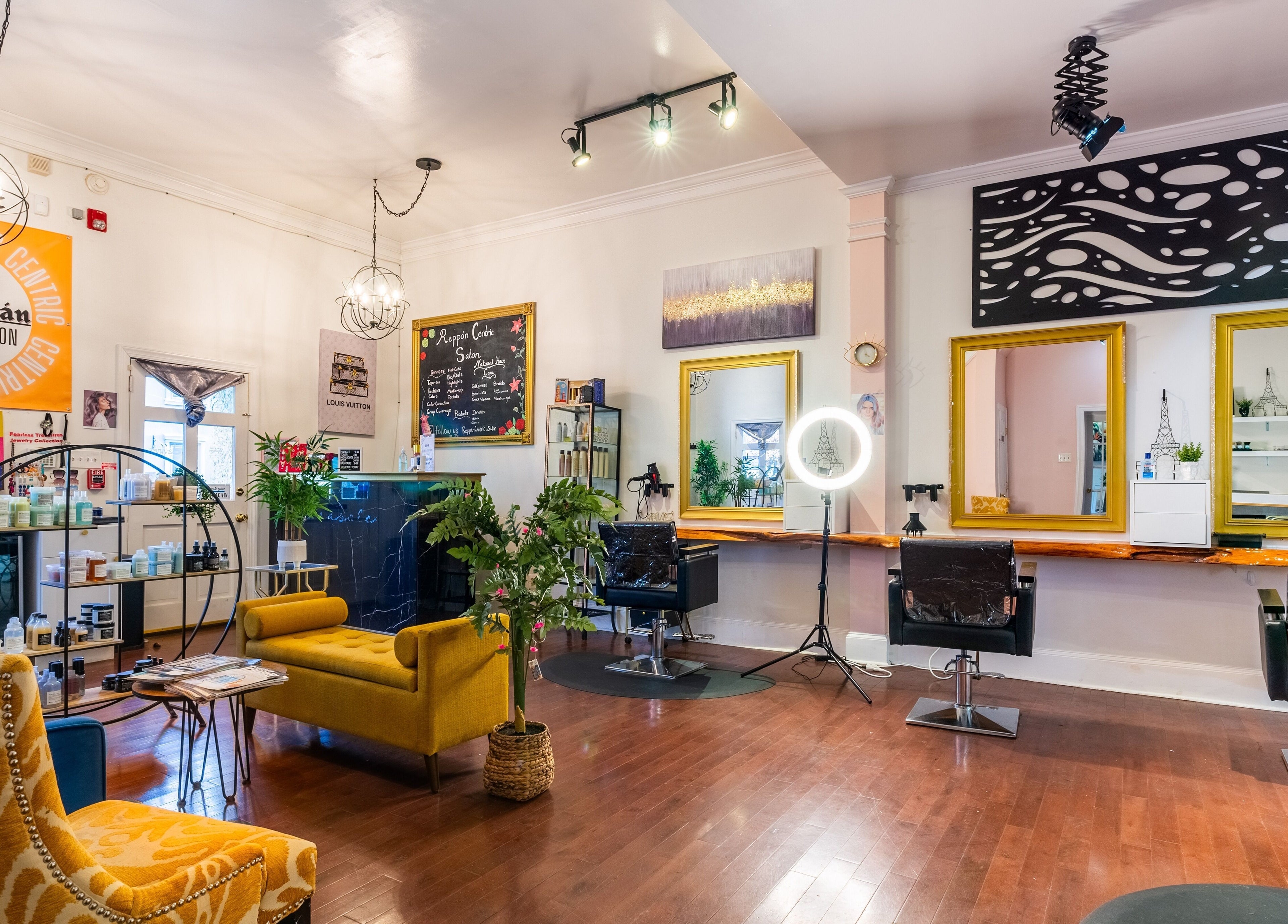Interior of Reppán Centric Salon in Philadelphia, Pennsylvania, US, featuring vibrant decor and stylish seating.