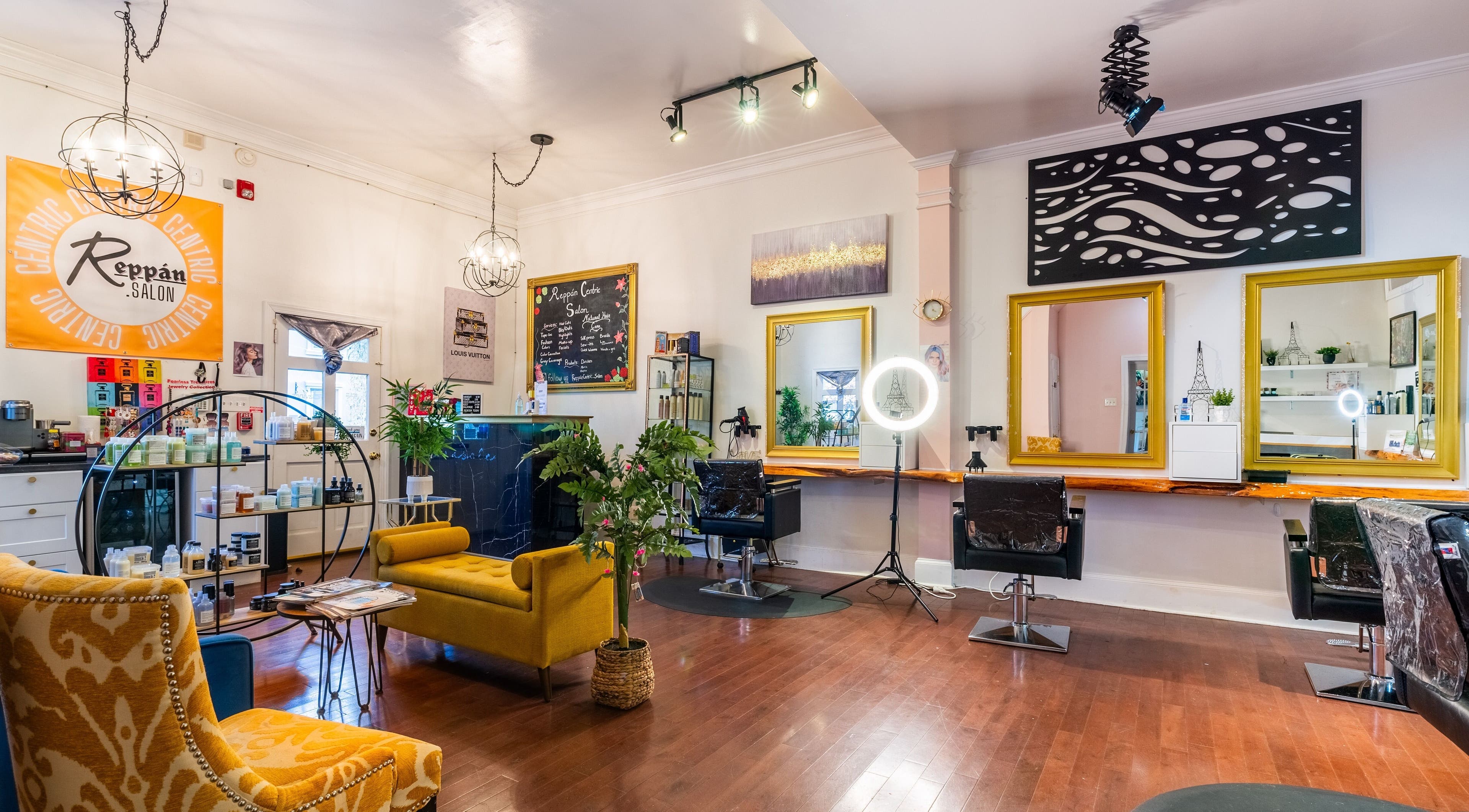 Interior of Reppán Centric Salon in Philadelphia, Pennsylvania, US, featuring vibrant decor and stylish seating.