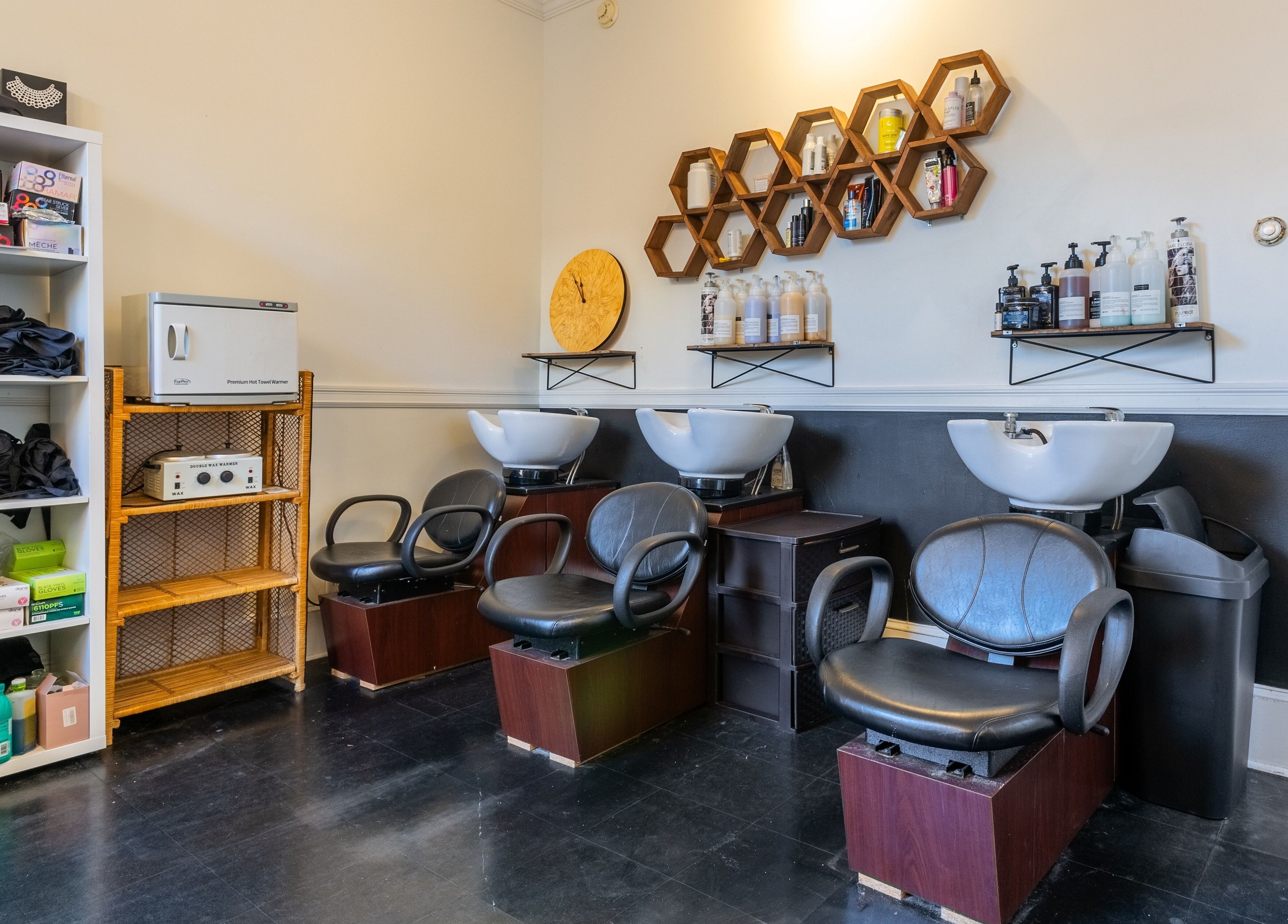 Washing station at Reppán Centric Salon in Philadelphia, Pennsylvania, US with modern chairs and products.