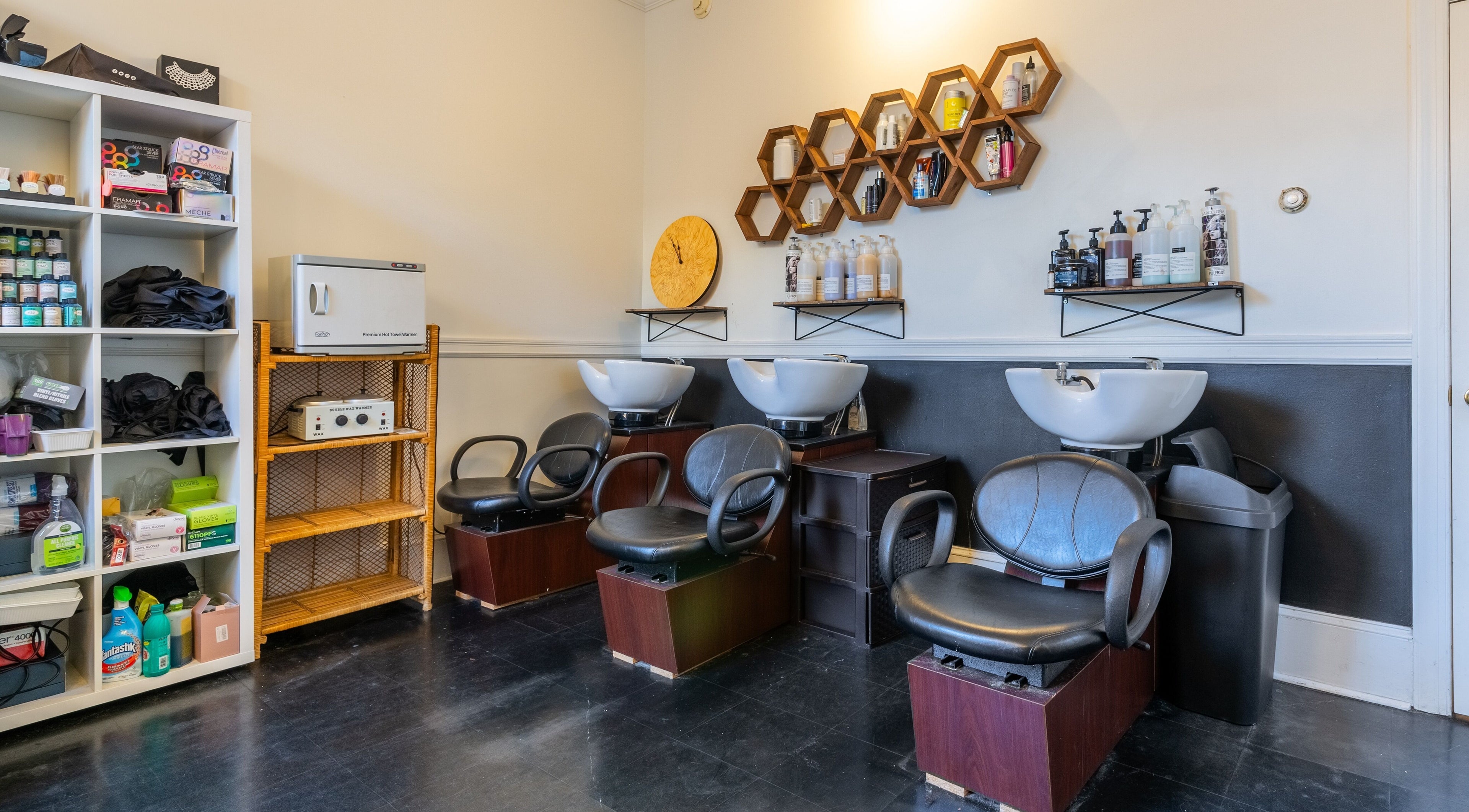 Washing station at Reppán Centric Salon in Philadelphia, Pennsylvania, US with modern chairs and products.