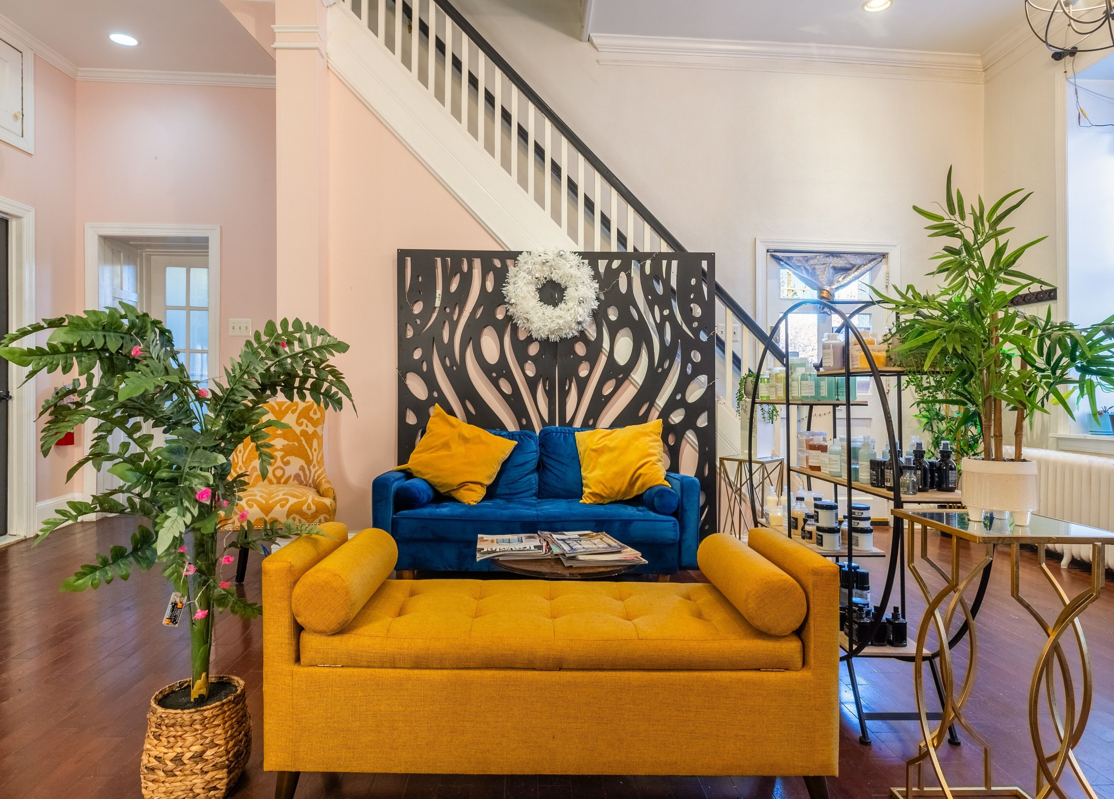 Chic lounge area at Reppán Centric Salon in Philadelphia, Pennsylvania, US with vibrant decor and comfortable seating.