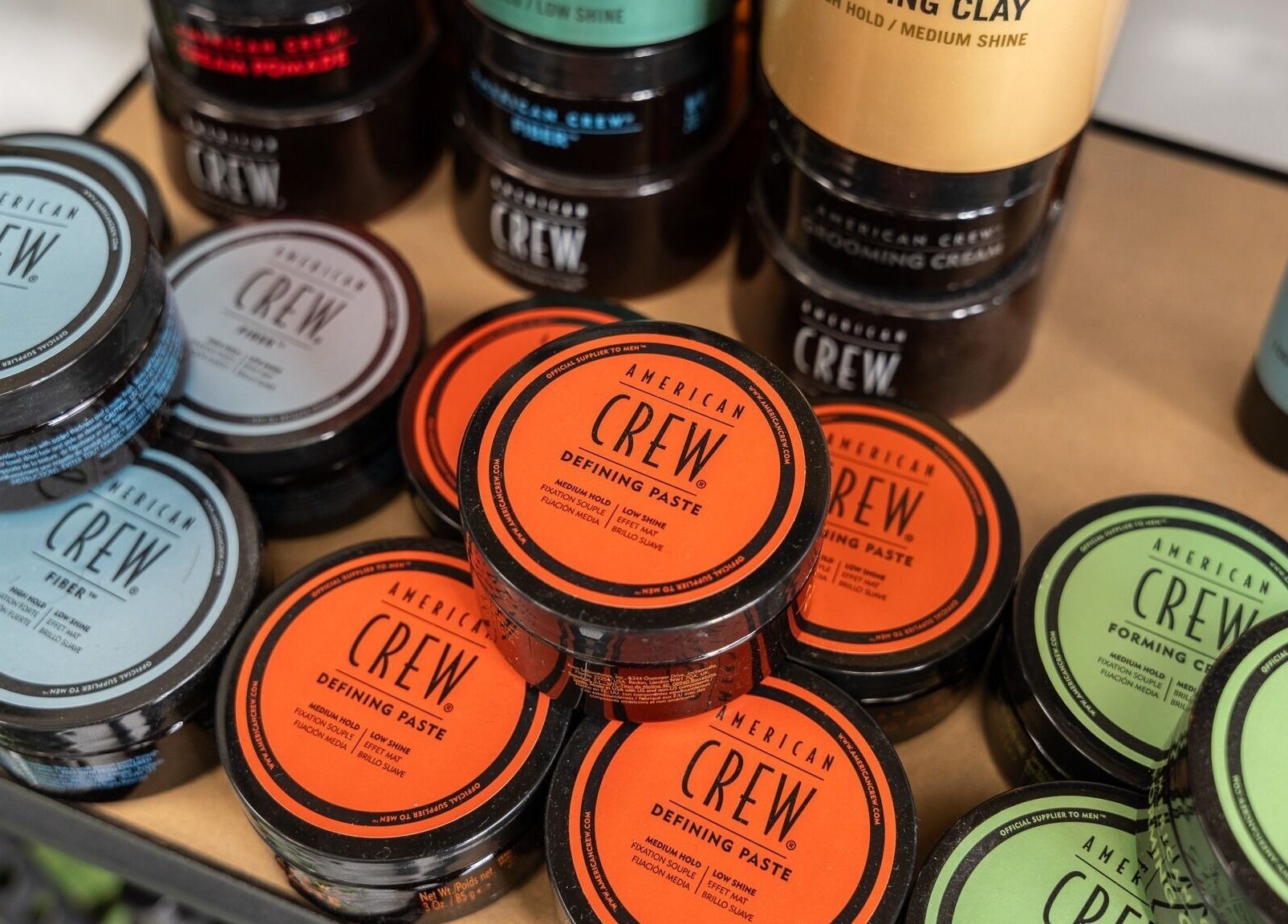 Close-up of hair styling products at Yallop, London, England, GB showcasing diverse grooming options.