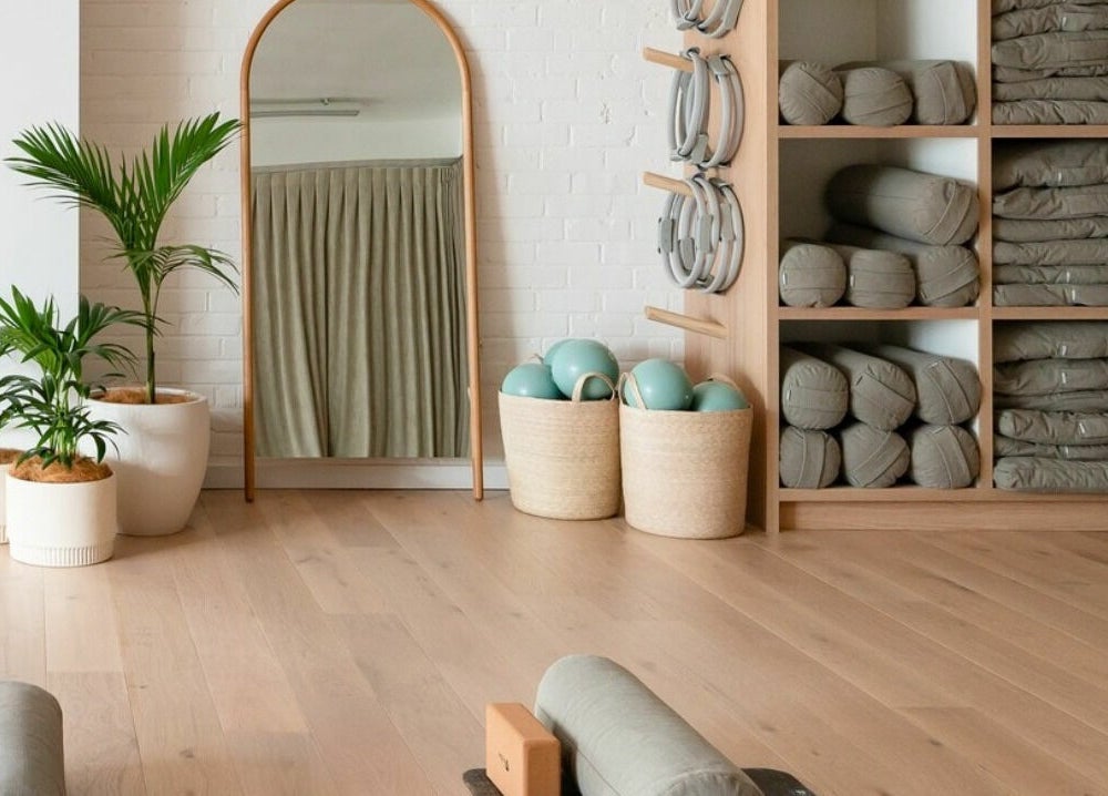 Yoga studio at Well and Being, Dunedin, Otago, NZ with plants, mirror, mats, and props.
