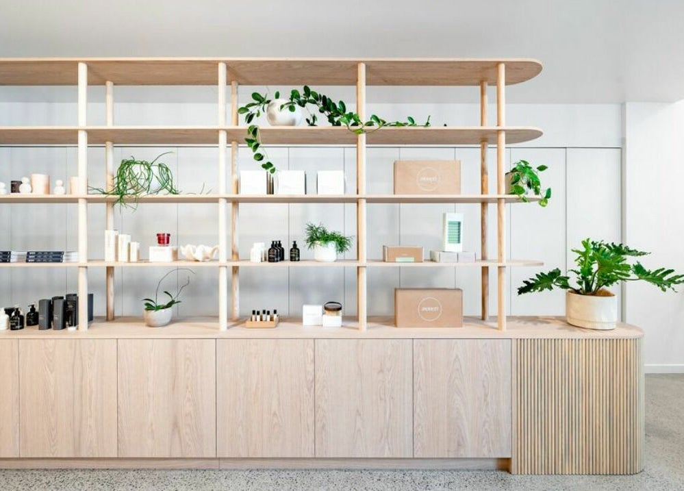 Modern wooden shelves with plants and products at Well and Being in Dunedin, Otago, NZ.