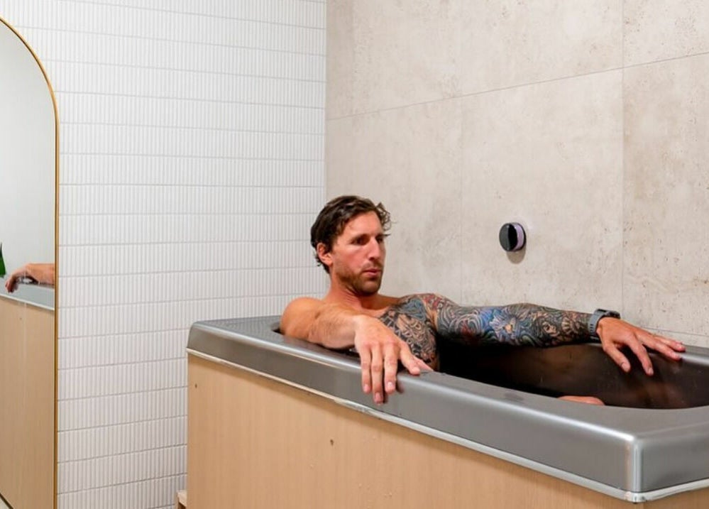 Man enjoying a relaxation bath at Well and Being, Dunedin, Otago, NZ wellness center.